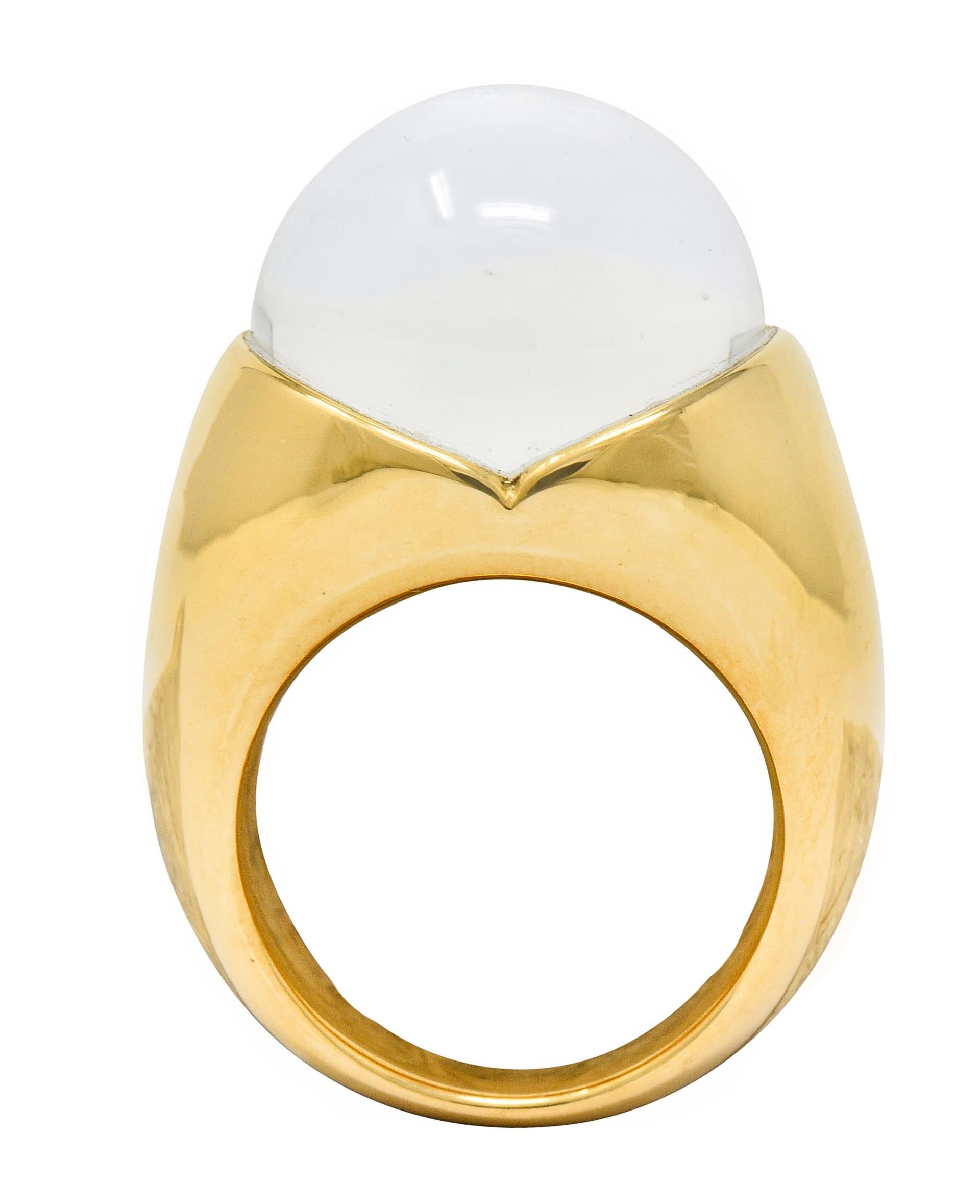Featuring a rock crystal sphere measuring approximately 15.6 mm

Nestled securely in a high polished gold mounting atop a flush set round brilliant cut diamond

Its size is magnified through the well polished and transparent rock crystal

Stamped
