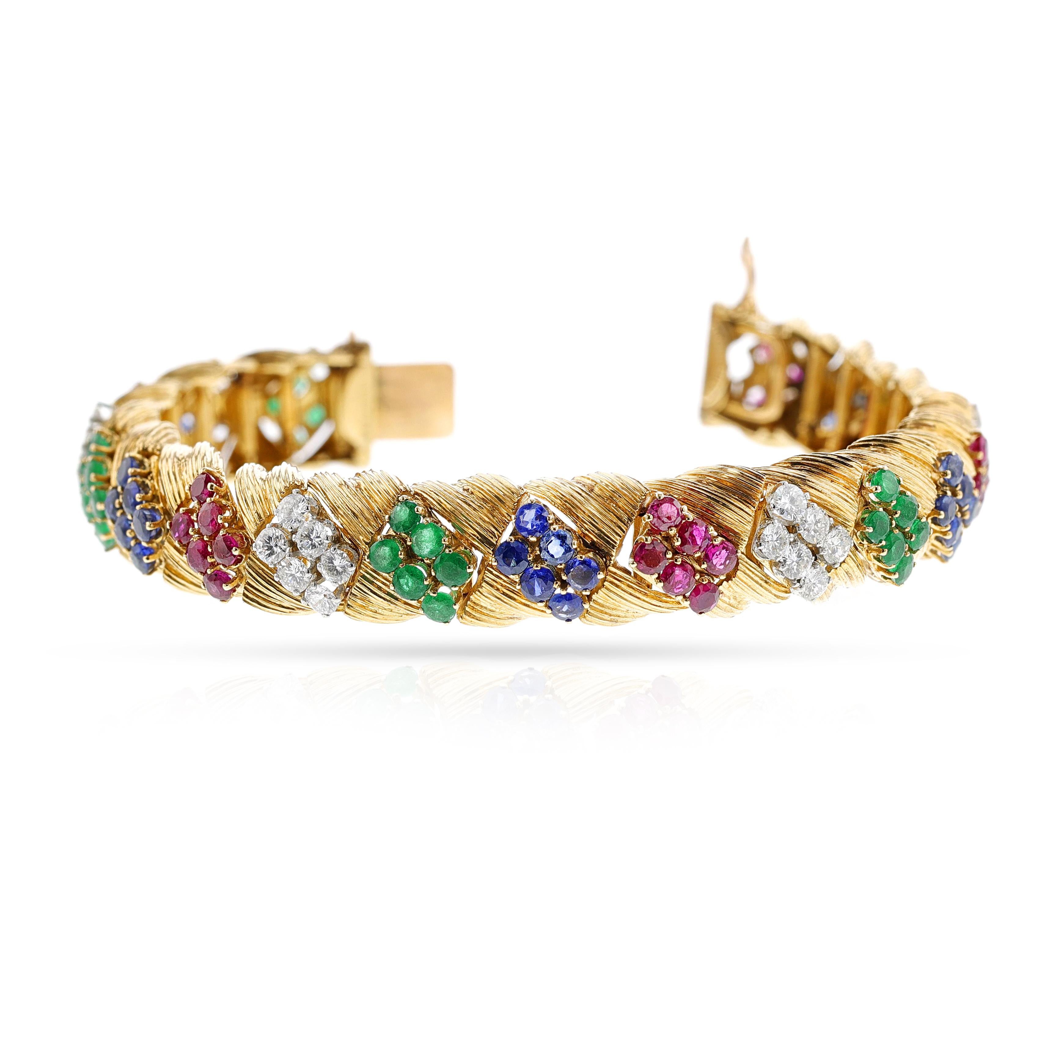 A Mauboussin Ruby, Emerald, Sapphire and Diamond Bracelet made in 18k Yellow Gold. Emeralds appx. 3.6 carats. Sapphires: appx. 4.5 carats. Rubies appx 4.5 carats. The diamonds weigh appx. 3 carats. The length is 7.
