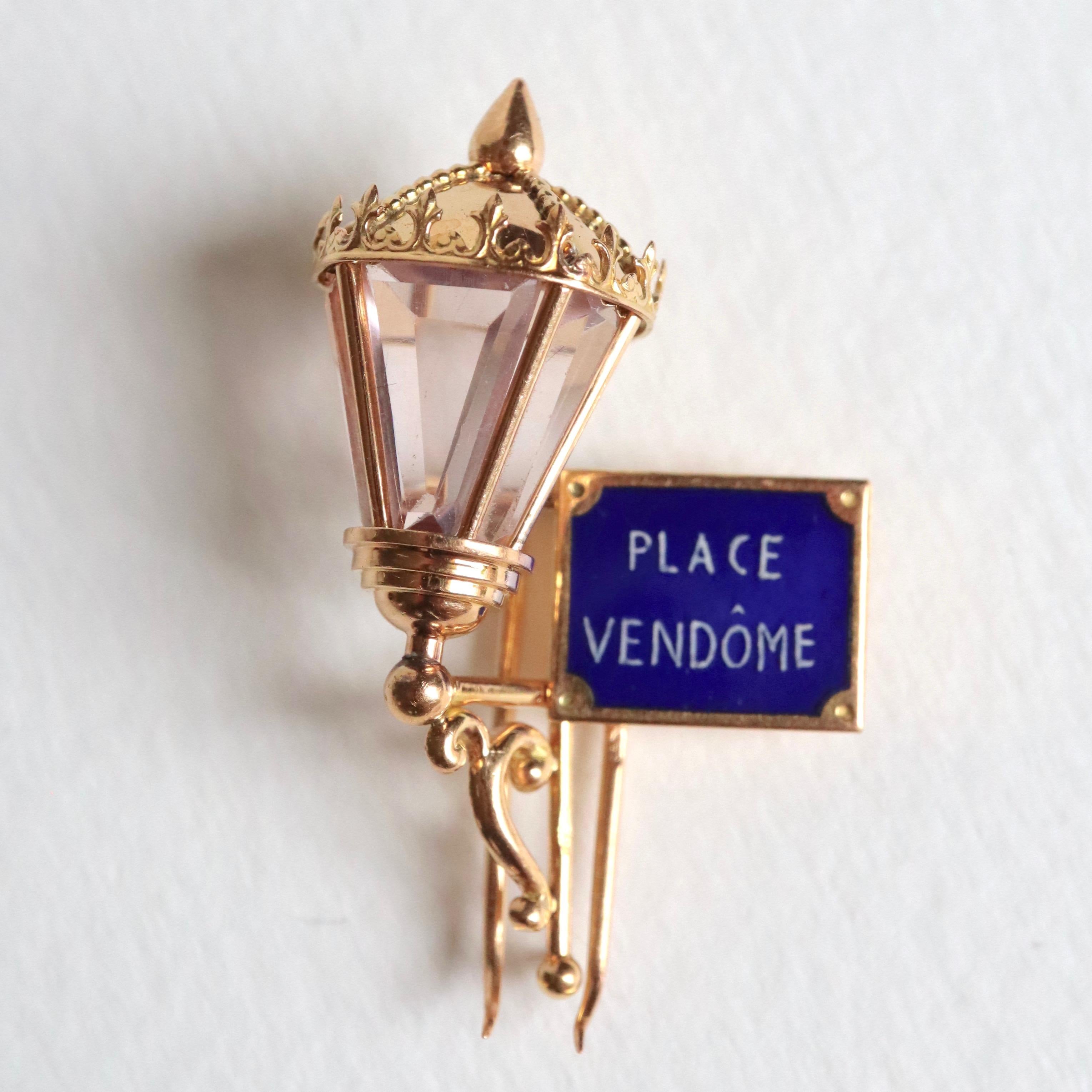 MAUBOUSSIN Place Vendôme Lapel Clip in 18 Carat yellow Gold and Enamel around 1950
Maison MAUBOUSSIN reverse Cuff in 18 Kt yellow Gold depicting a Lantern with the Plaque of the Vendôme Place Enamelled in White on a Blue Background. 3 beveled