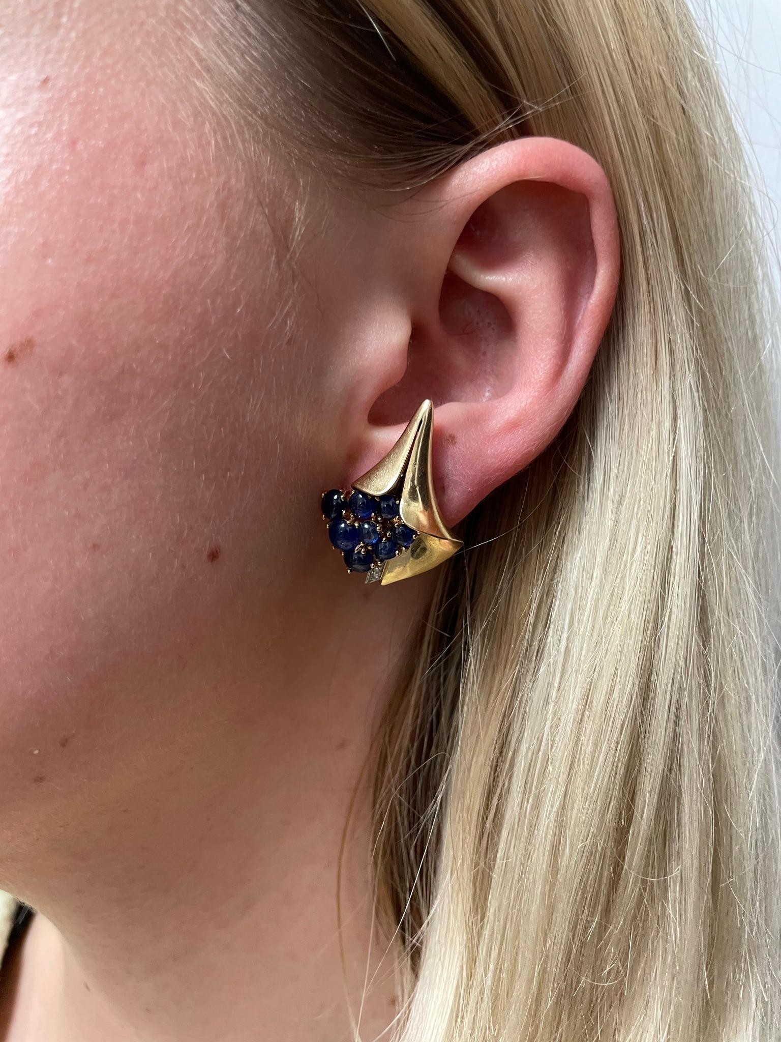 A pair of Mauboussin Sapphire Cabochon Earrings by Trabert & Hoeffer in the Reflection Collection by MAUBOUSSIN. There are 9 sapphire cabochons on each earring with Diamonds. The earrings are made in 18 Karat Yellow Gold. Designed and executed for