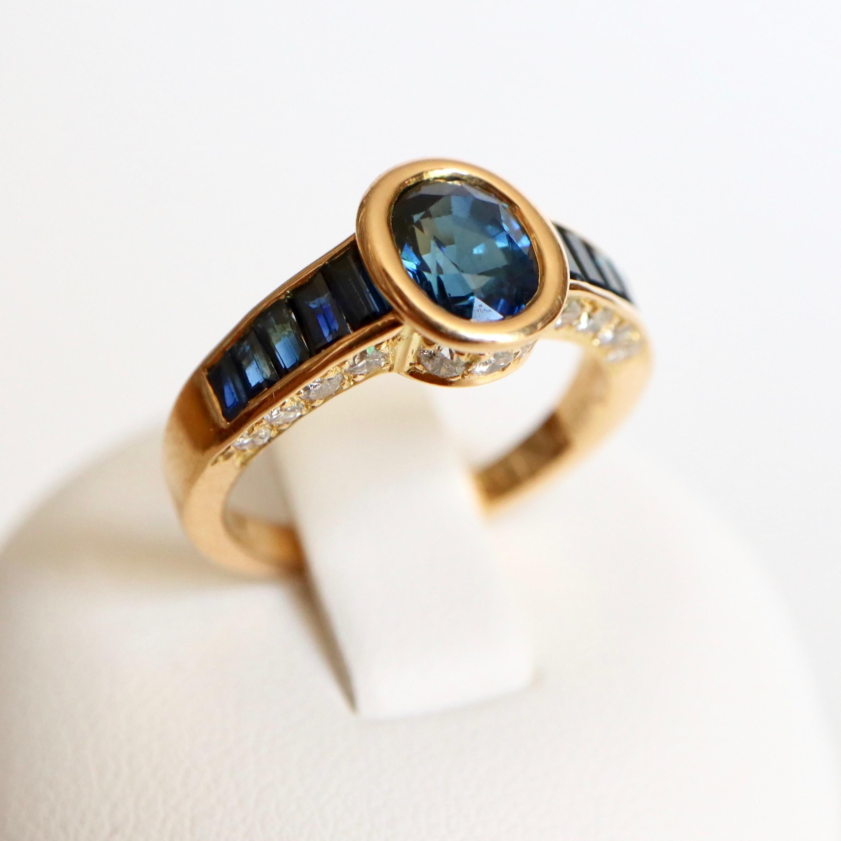 MAUBOUSSIN Ring in 18K yellow Gold Sapphires and Diamonds. Ring retaining a Closed Sapphire set with 5 calibrated Sapphires on both Sides. The Body of the Ring is set with 11 Diamonds on each Profile.
Signed MAUBOUSSIN and numbered. French