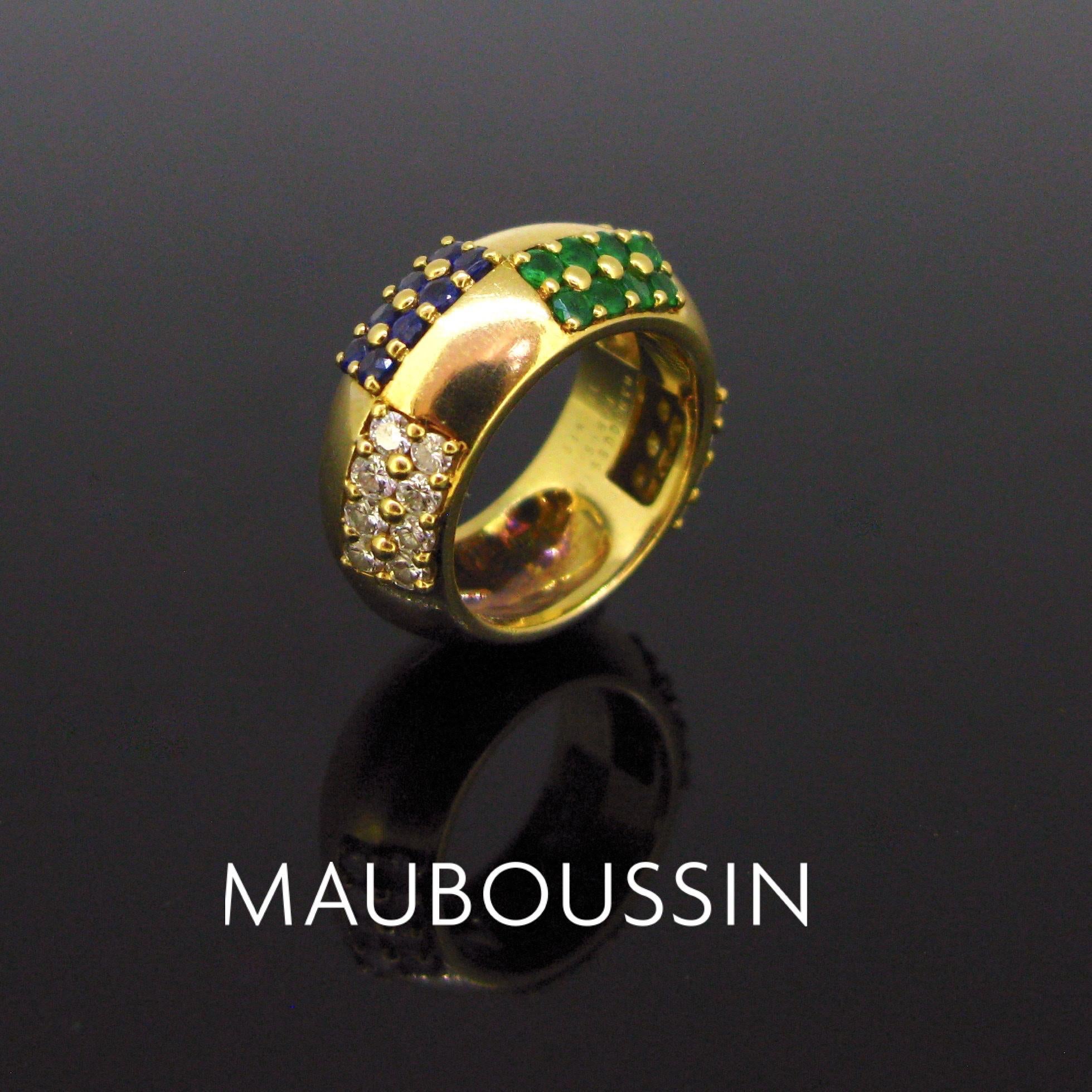 This beautiful bold band vintage ring is set with diamonds, sapphires and emeralds. The ring is made in 18kt yellow gold and it is in good vintage condition. It is signed Mauboussin inside the band and marked with the French eagle’s head. Ring size: