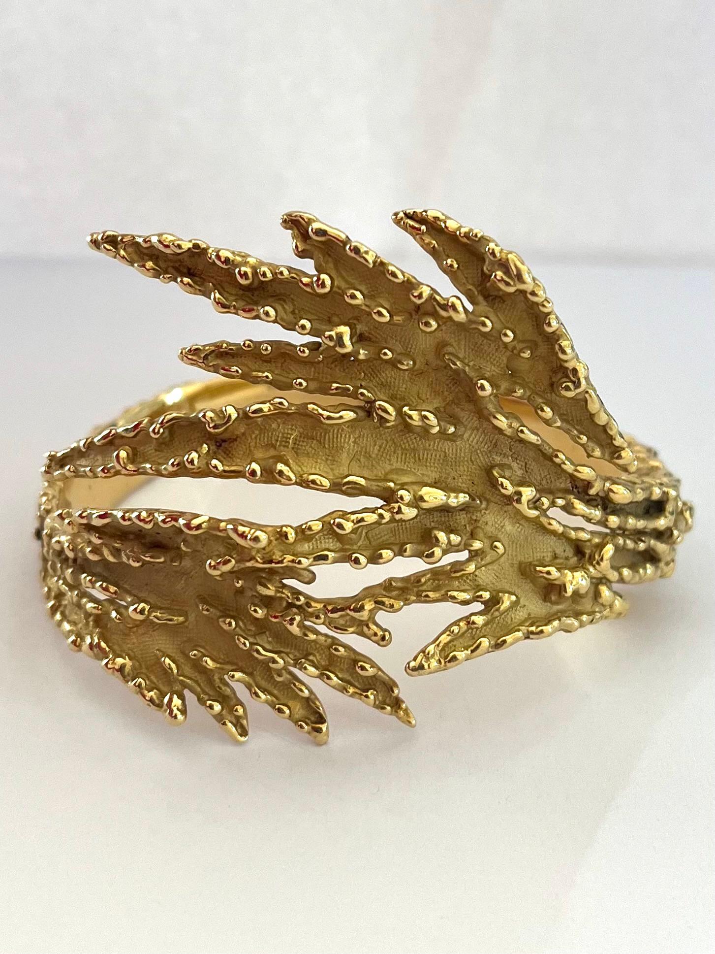 Striking Sculptural bracelet in textured gold. The technique used is fan ancient one called filigree. The design is both organic and sculptural which represents the Modernist movement in Jewelry. Made in the 70s. Signed Mauboussin Paris.