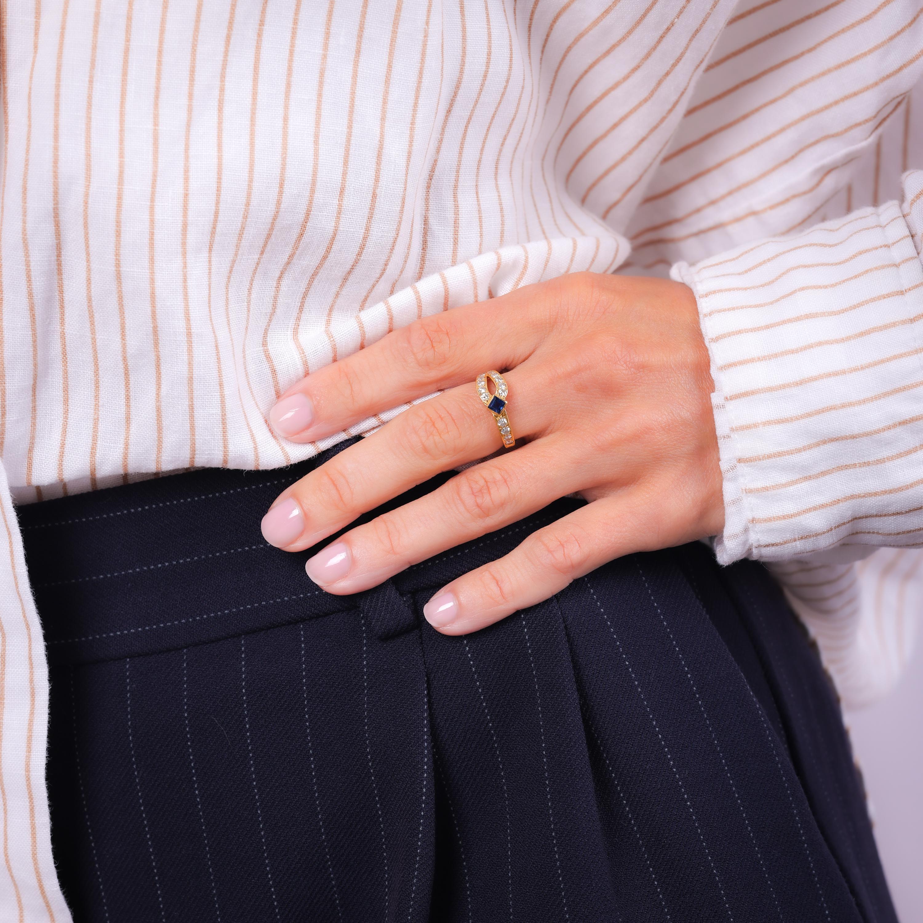 Brand: Mauboussin Paris
Center Stone: Carre Cut Blue Sapphire
Weight: Approximately .25 Carat
Accent Stone: 15 Round Brilliant Cut Diamonds
Weight: Approximately .70 Carats
Color: F
Clarity: VS
Metal: 18K Yellow Gold
Era: Vintage
Circa: