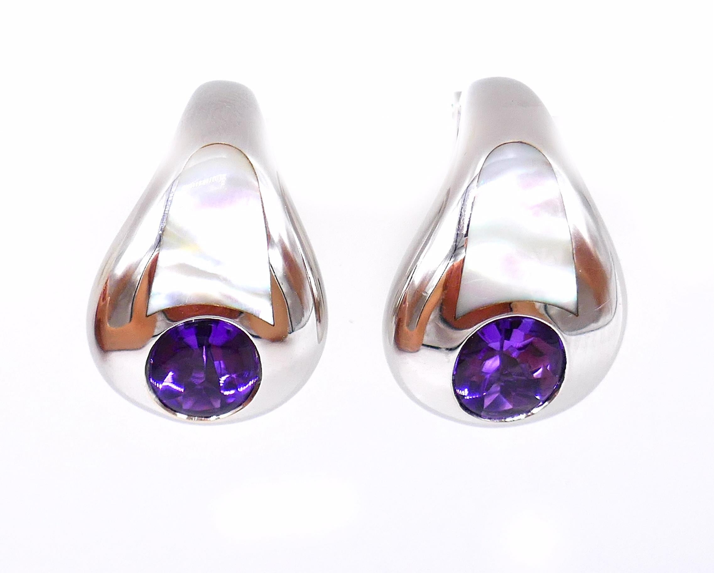 Vintage clip-on earrings by Mauboussin made of 18k white gold featuring amethyst and mother of pearl. Stamped with the Mauboussin maker's marks, a hallmark for 18k gold and a serial number. 
Measurements: 7/8