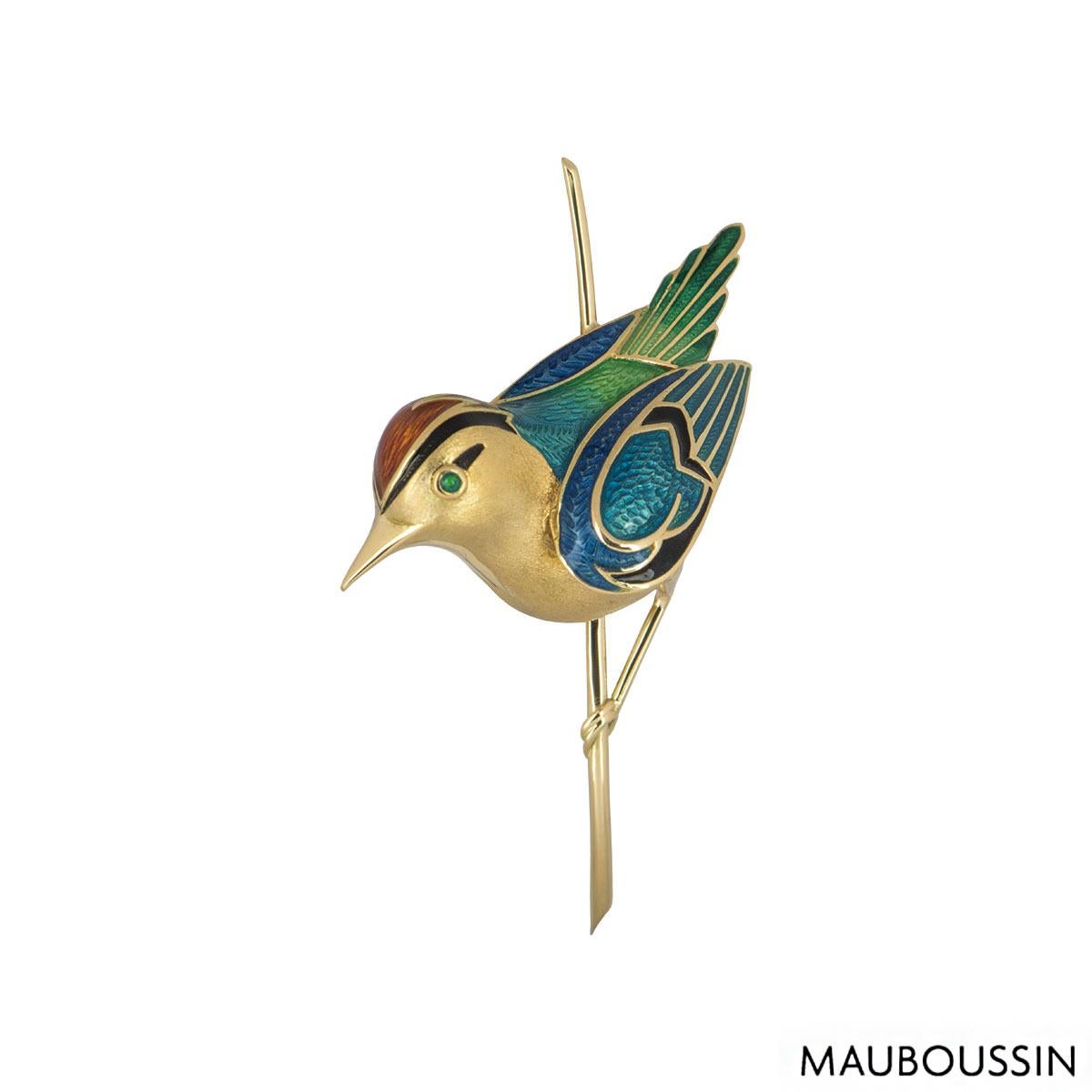 An 18k yellow gold bird brooch by Maboussin. The bird brooch is partially set with polychrome guilloché enamel on the wings and body of the bird with a coloured stone eye. The brooch is fitted with a trombone clasp with a height 5.60cm, length of