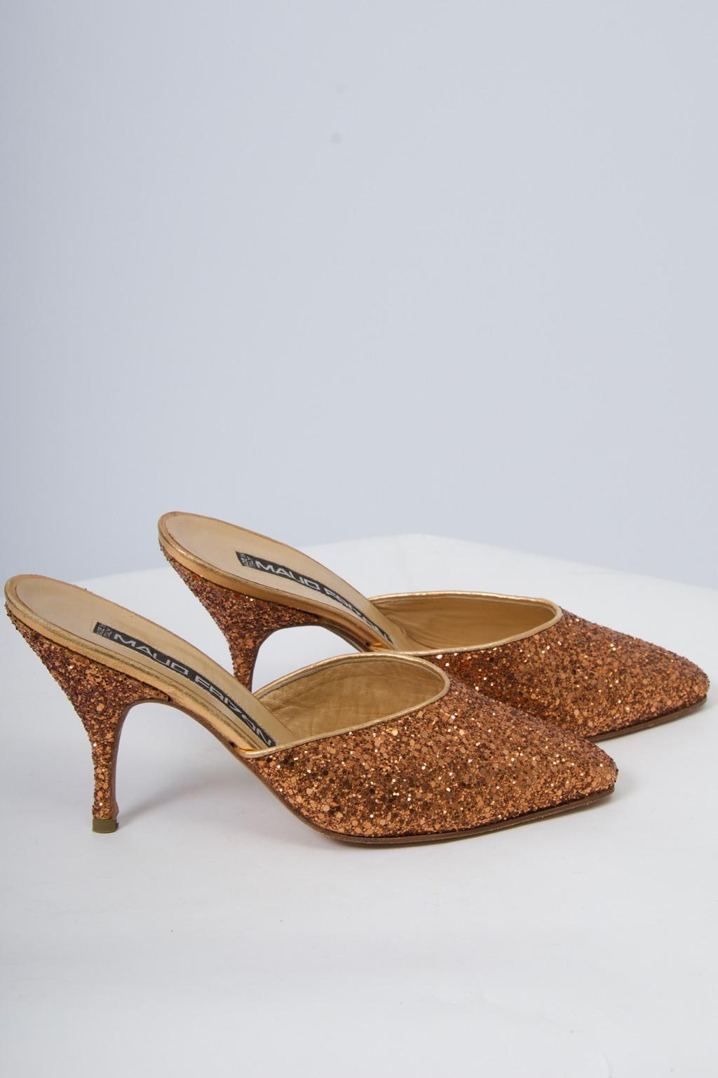 A great find, these Maud Frizon mules provide plenty of sparkle for the holidays and beyond. Edges bound in gold leather. Mid-size slender heel. Size 37. Never worn.