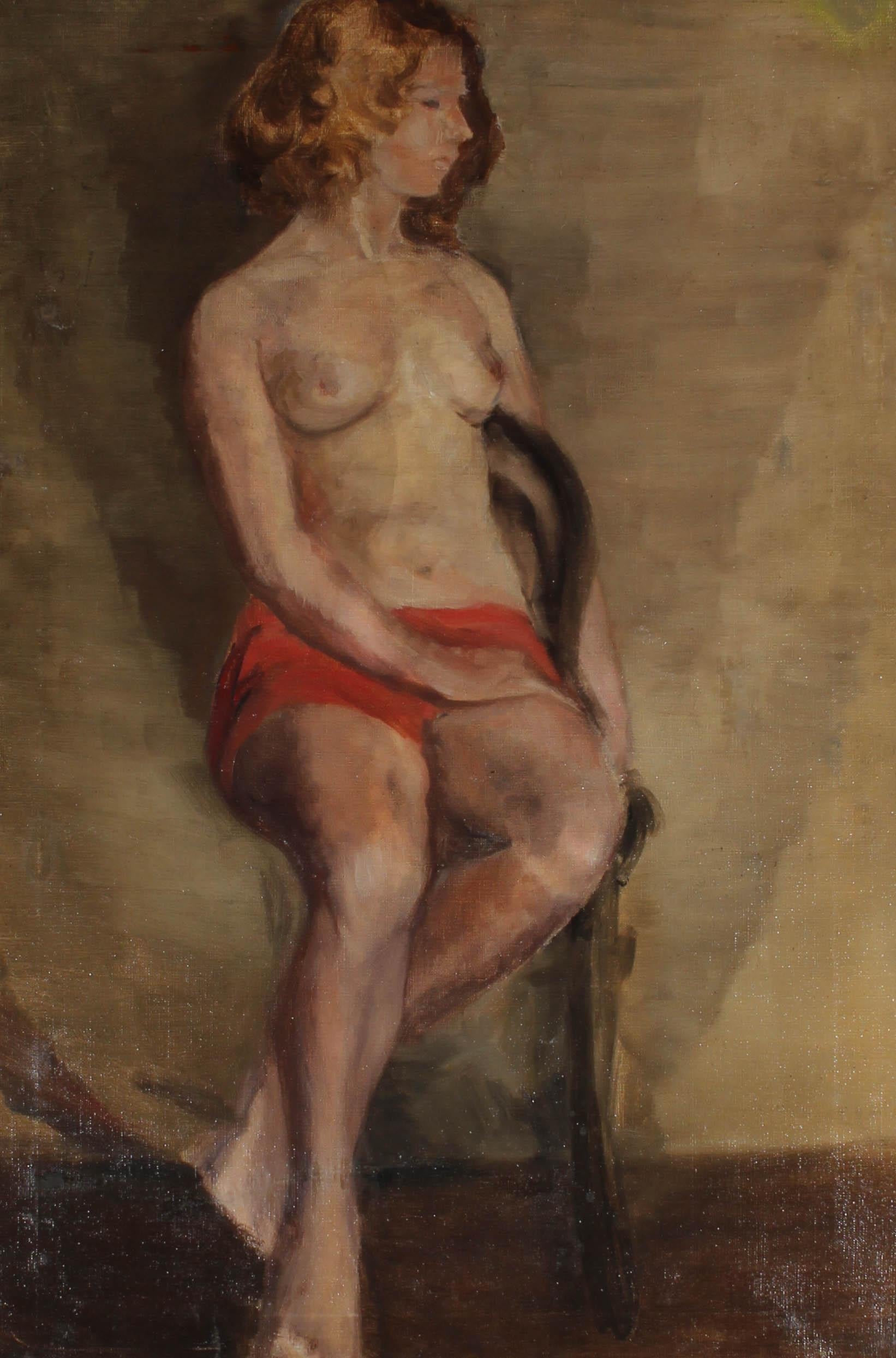 The beautiful mid-century oil depicts a partially nude model seated on a wooden chair. She wears red shorts that are a pop of colour against the dark background. The artist shows her with her head turned, showing the graceful profile of her face.