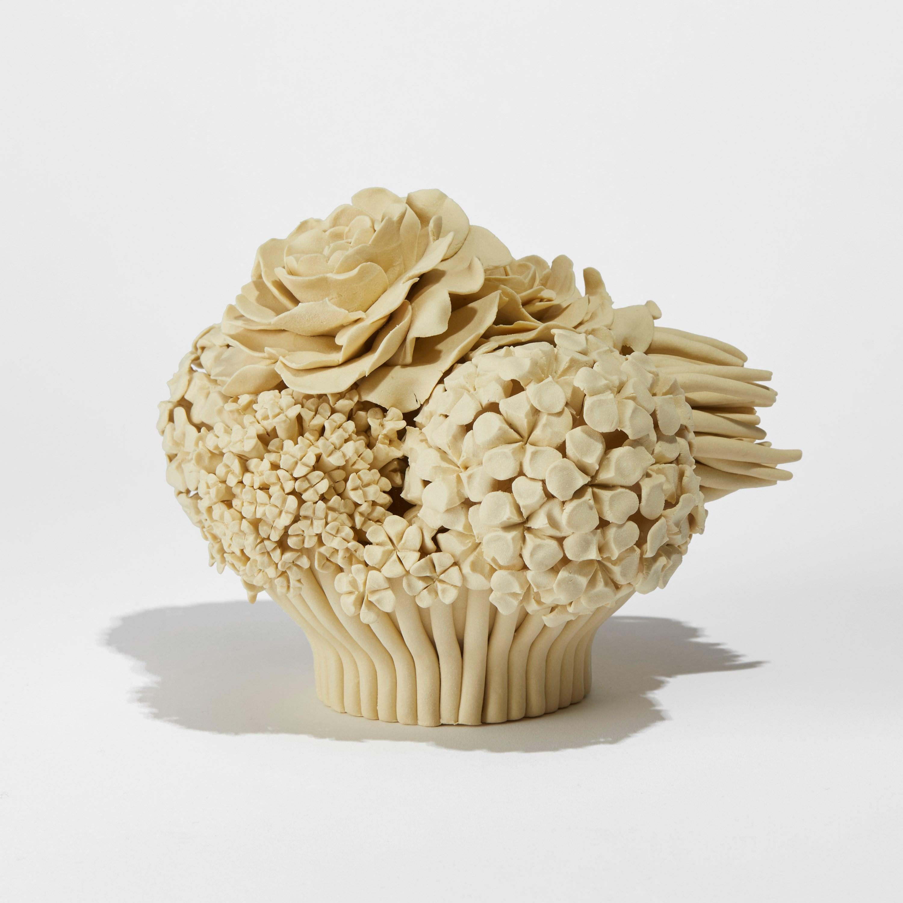 Maude, is a unique handcrafted soft primrose yellow porcelain sculpture and centrepiece completely covered in individually made porcelain flowers of all different shapes and forms by the British artist, Vanessa Hogge.

Vanessa Hogge breathes life