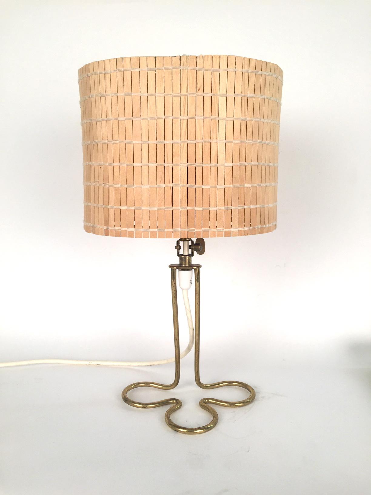 A Finnishtable lamp designed in the 1950s by Mauri Almari in the style of Paavo Tynnel. Brass and wooden rods. Excellent condition.