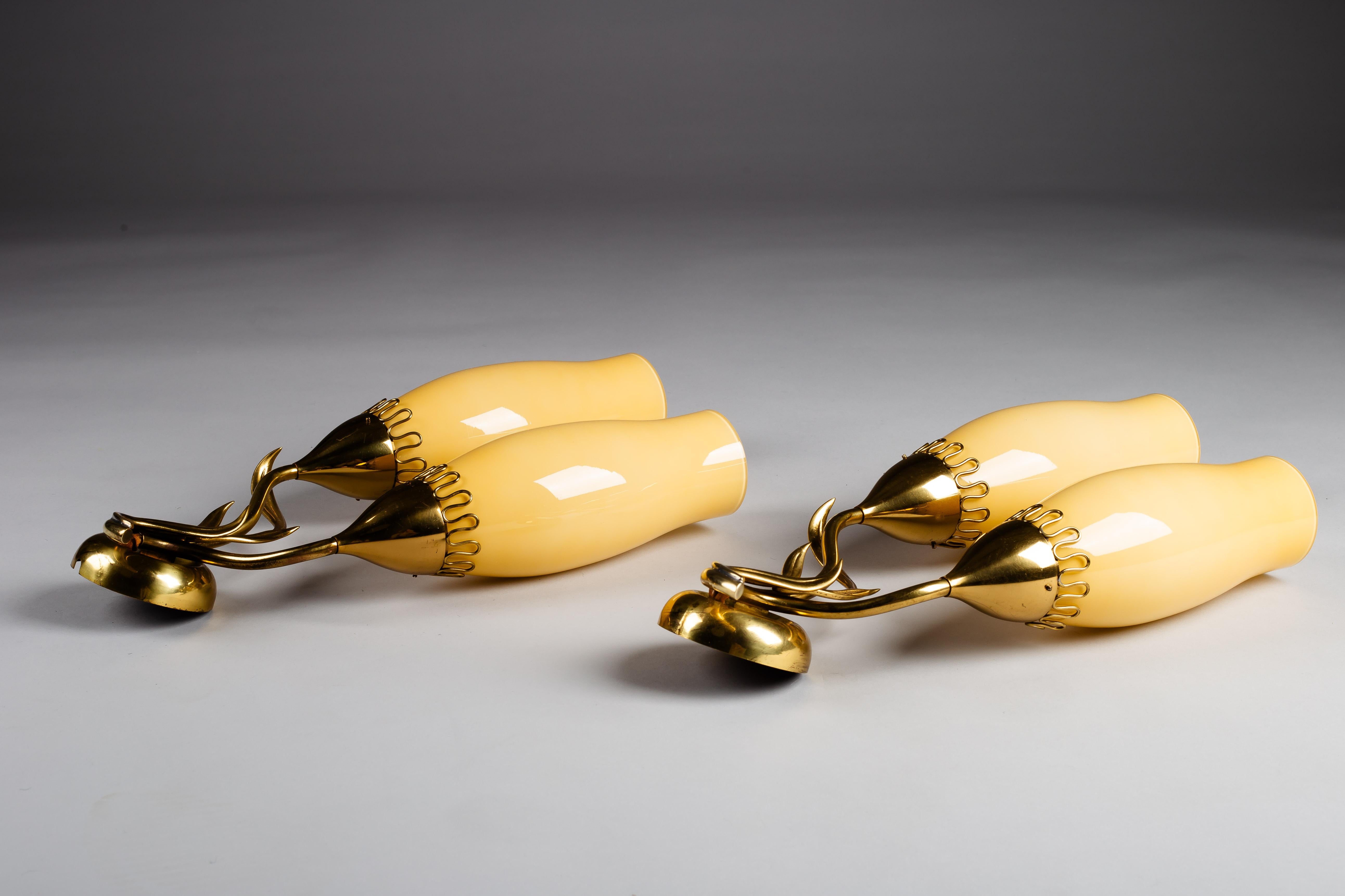 Add a touch of mid-century elegance to your home with the Mairi Almari wall sconces from Idman Oy. These exquisite 1950's large brass wall sconces feature stunning amber colored glass shades that emit a warm, ambient glow. Celebrate Scandinavian