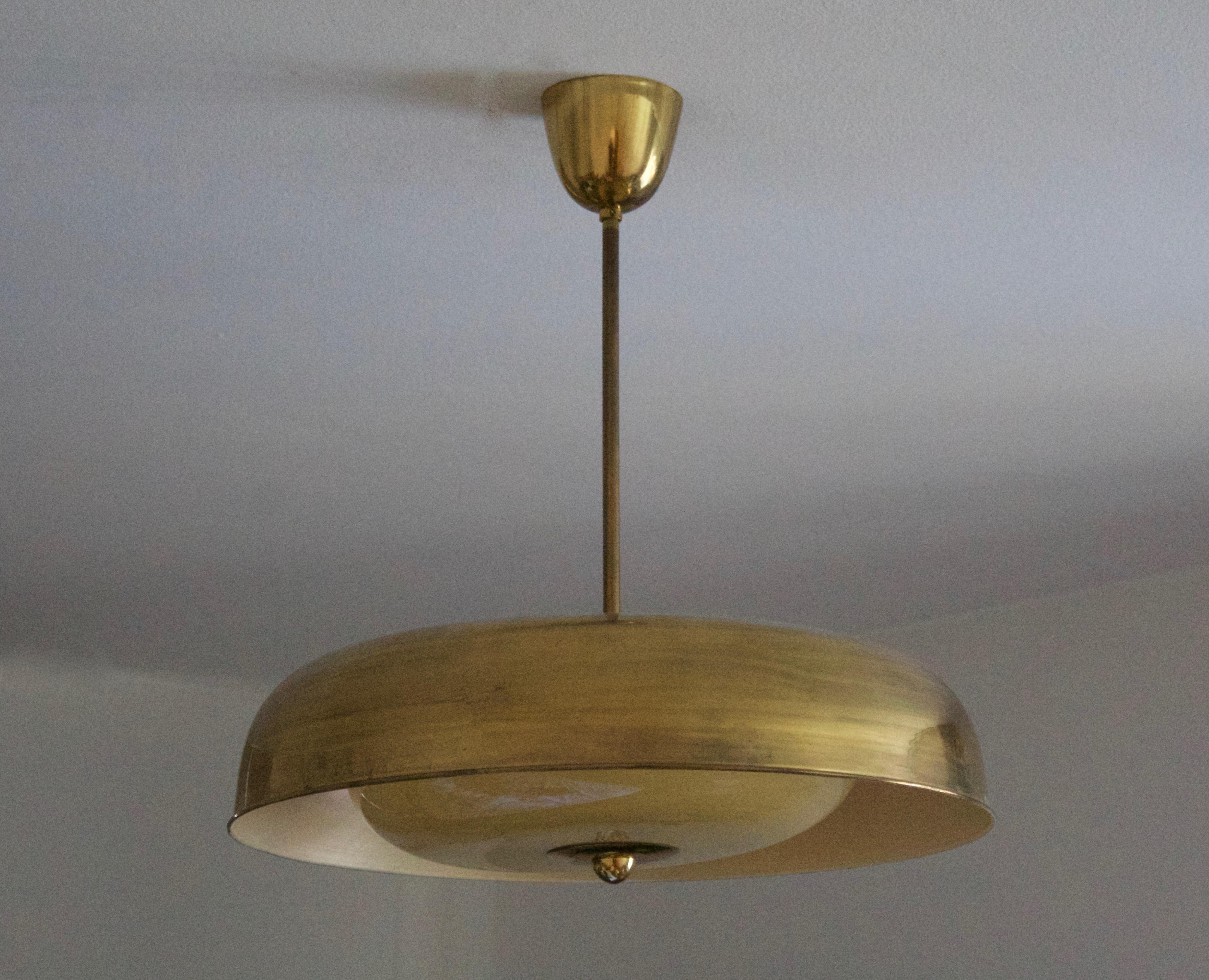 A sizable pendant light, designed by Mauri Almari for Idman, Finland, 1950s. In brass with its original cream-colored glass diffuser.

Inside of glass diffuser takes 4 lightbulbs on E27 bases. In addition, there are two sockets for E27 bases on