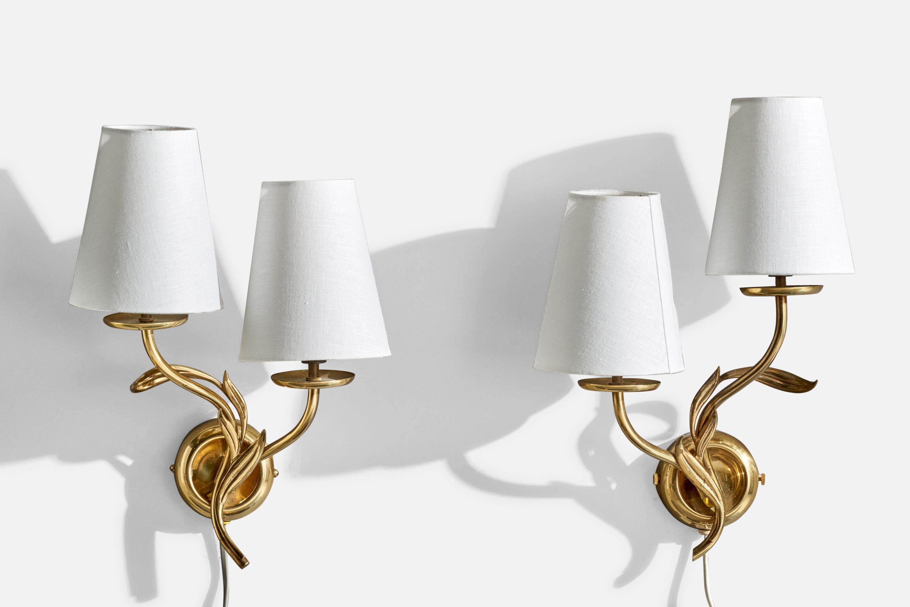 A pair of brass and white fabric wall lights designed by Mauri Almari and produced by Idman, Finland, 1950s.

Overall Dimensions (inches): 15.5” H x 11” W x 5” D
Back Plate Dimensions (inches): 3.55” H x 1.10” D
Bulb Specifications: E-26 Bulb
Number