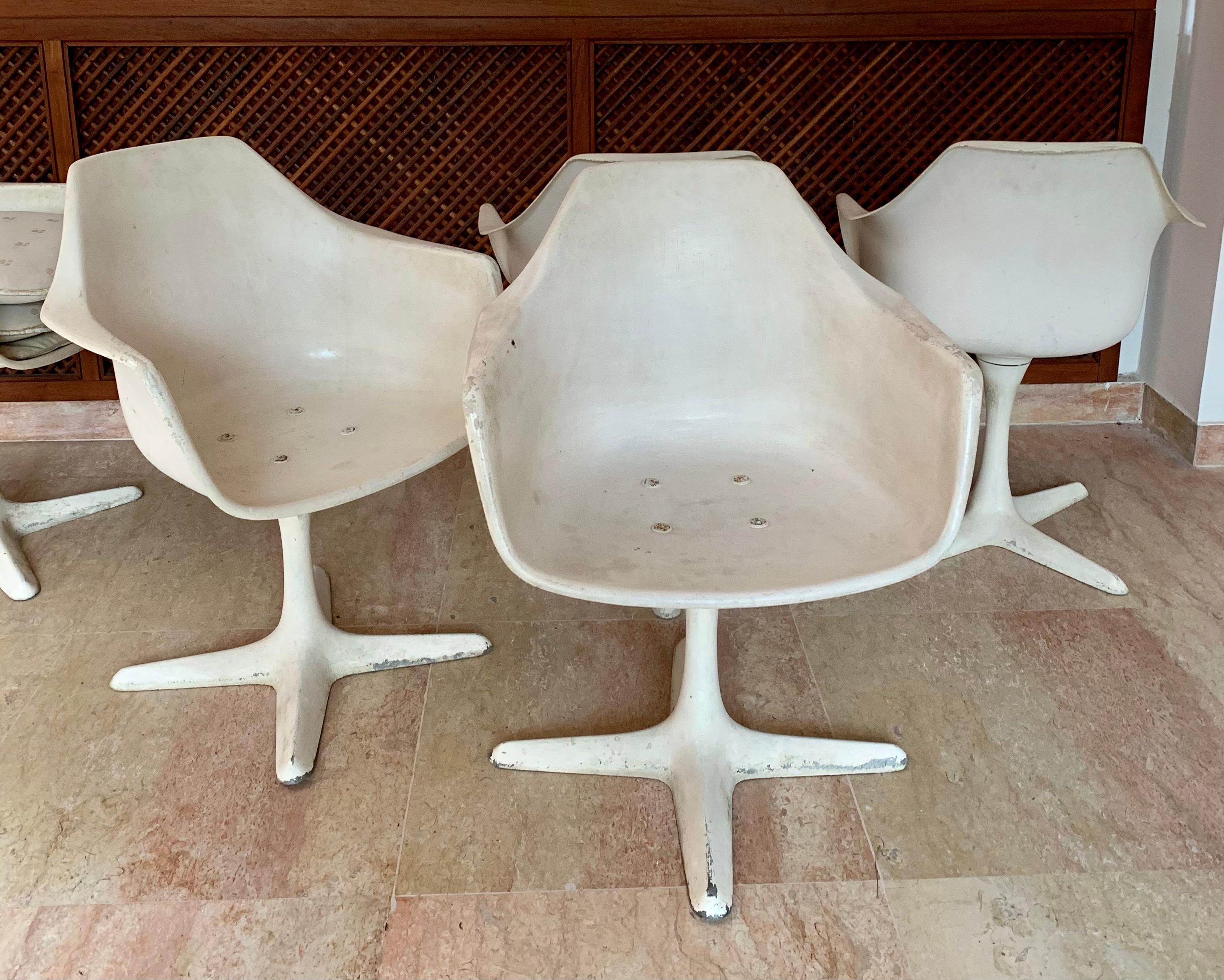 
6 Midcentury modern Maurice Burke armchairs made for Arkana , a British furniture manufacturer. White molded fiberglass chairs raised on a 4 aluminium leg base. Marked underside of seat with Arkana 116 .
