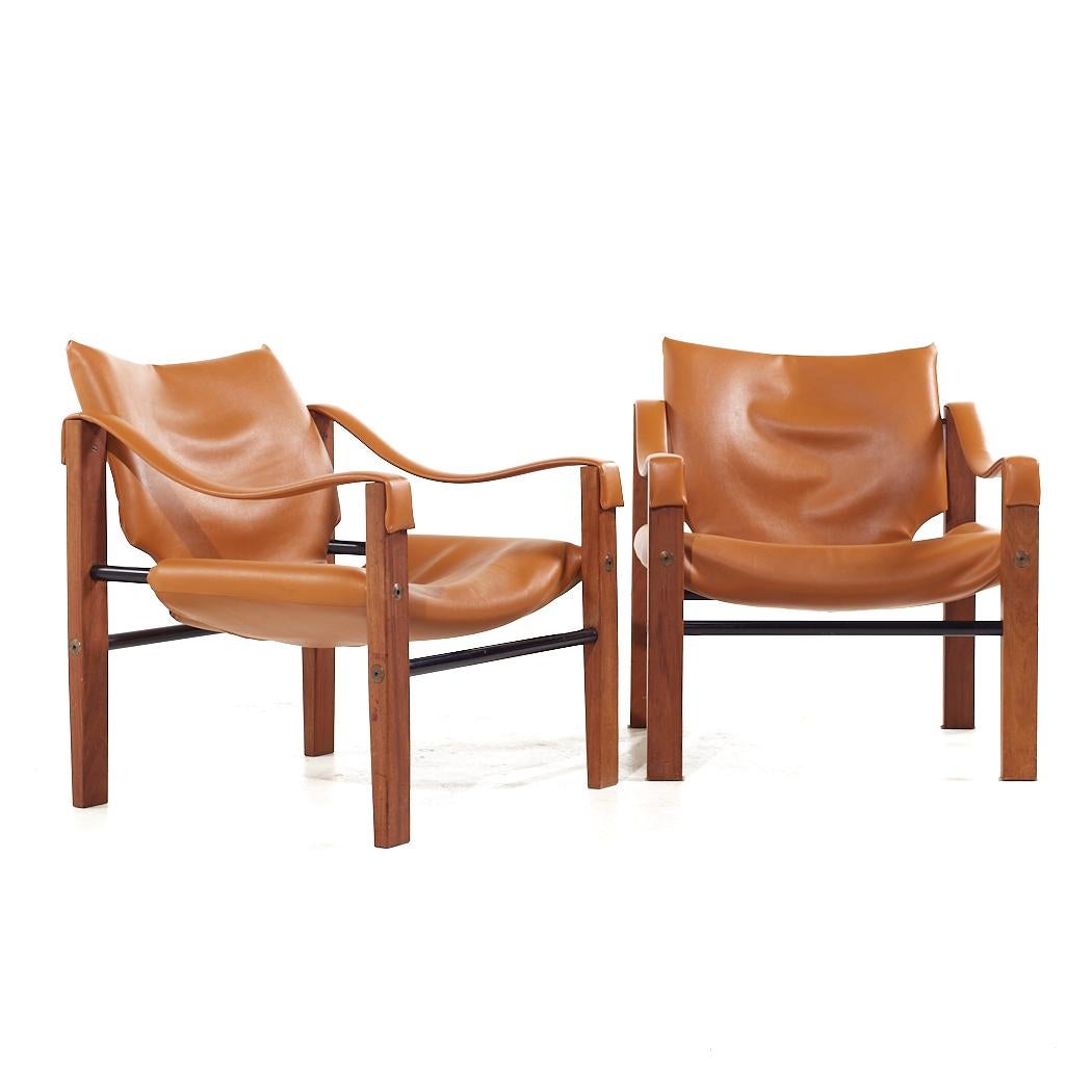 Maurice Burke Mid Century Teak Safari Arkana Lounge Chairs - Pair

Each lounge chair measures: 24.5 wide x 28 deep x 27.75 high, with a seat height of 13.5 and arm height/chair clearance 20.5 inches

All pieces of furniture can be had in what we