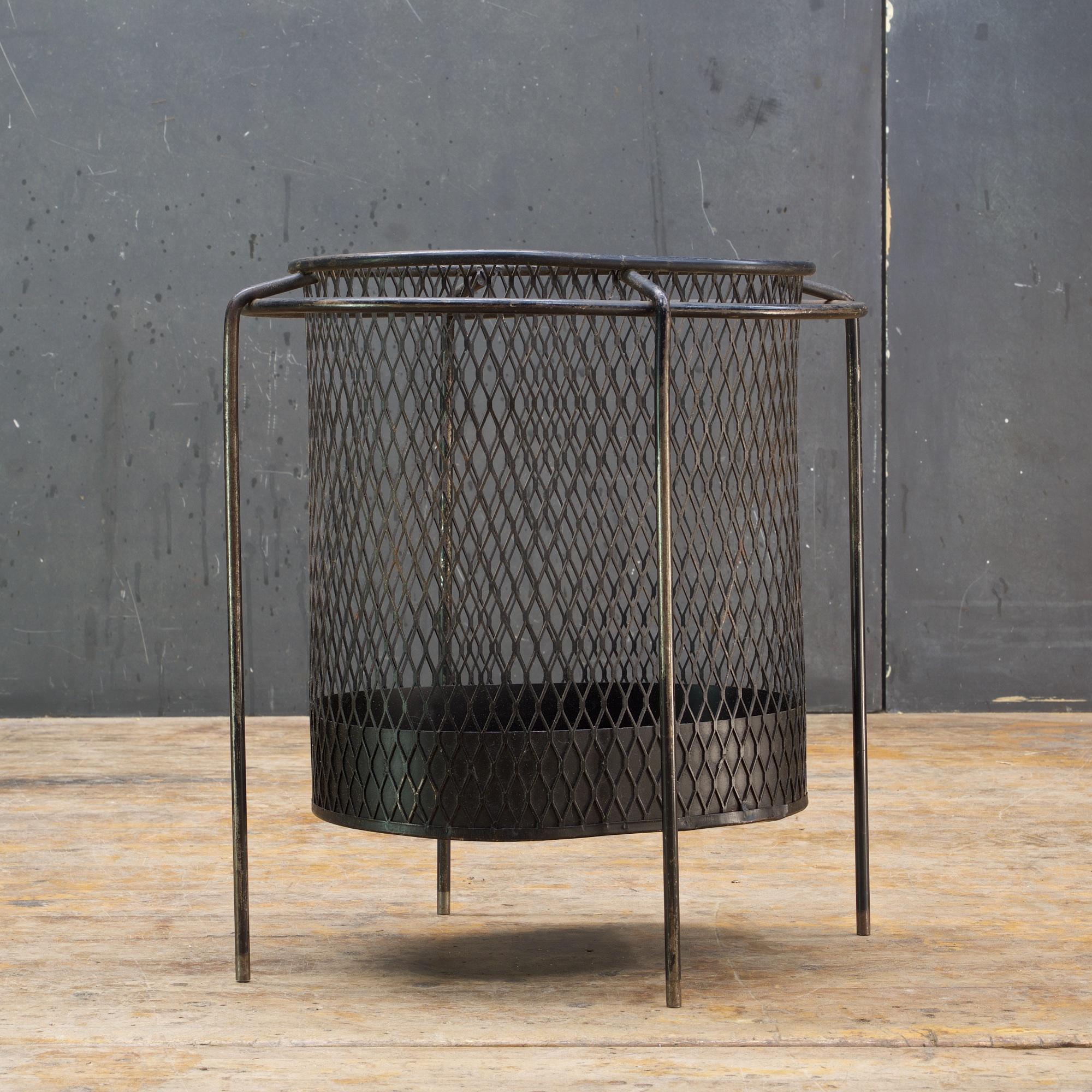 Black enameled steel suspended basket in iron rod frame. Showing some wear and bend to iron rods.