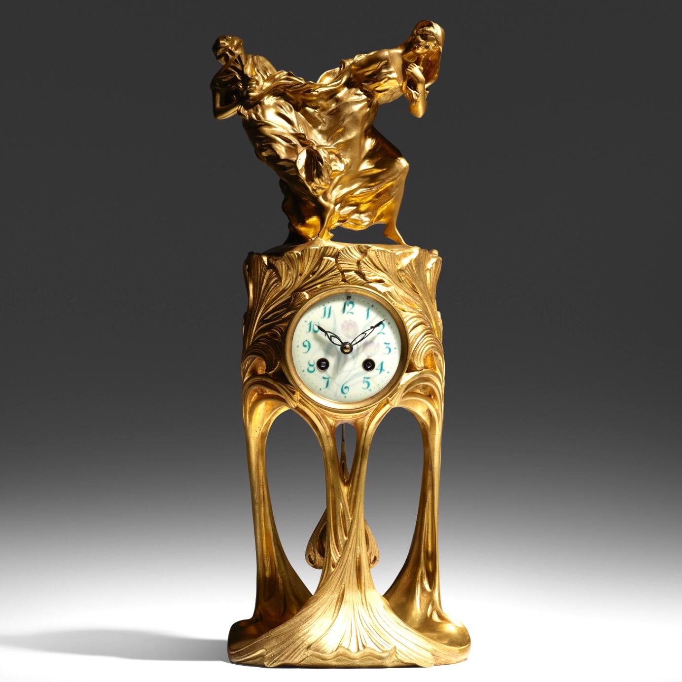 Maurice Dufrêne and Félix Voulot 
Rare Art Nouveau Gilt Bronze Museum Clock
Paris France, circa 1900
Gilt bronze, enameled metal
Dimensions: 21.5 × 9 × 8 inches (55 × 23 × 20 cm)

Art nouveau clock features two dancing figures in flowing