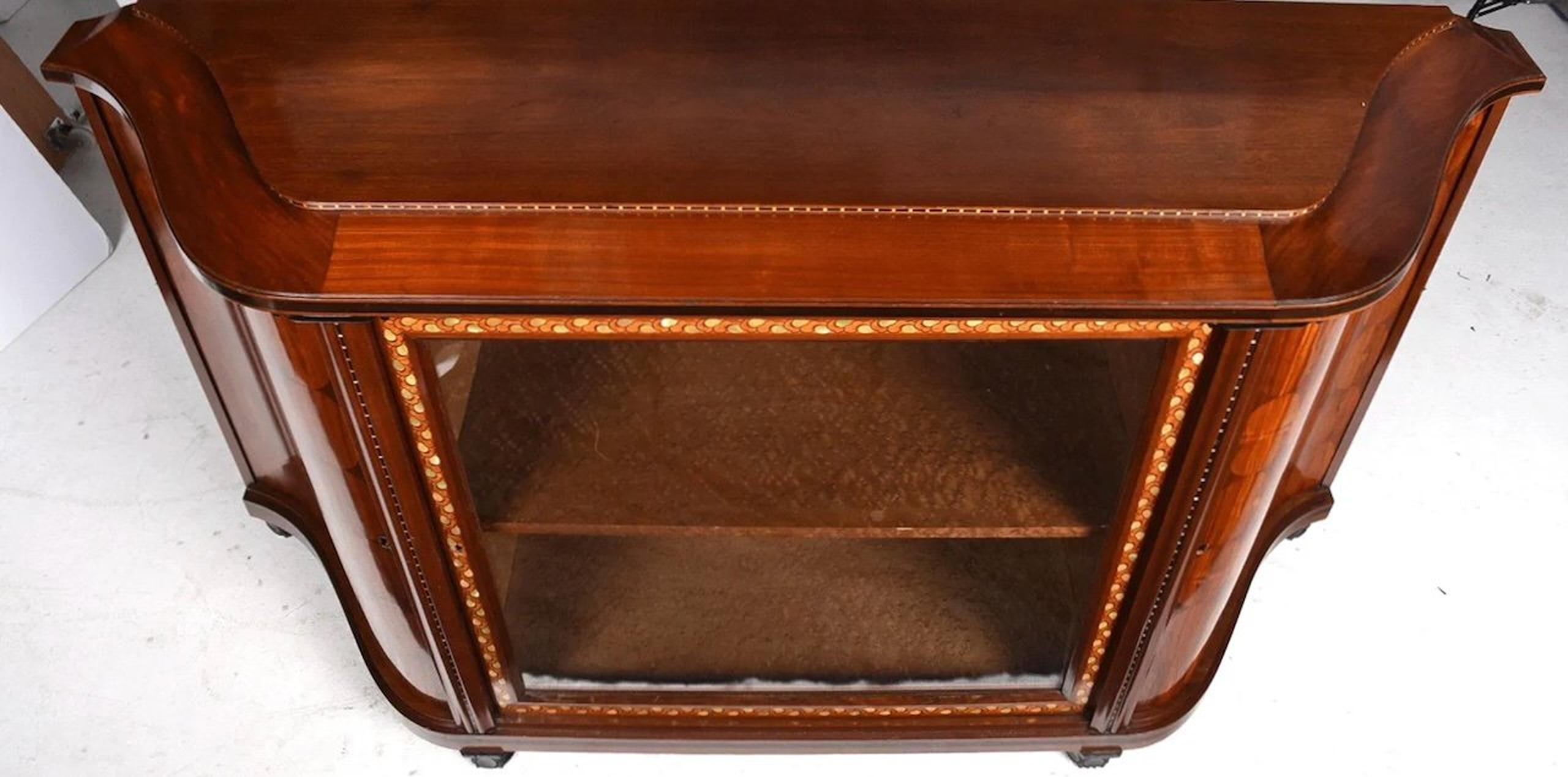 Classic French Art Deco cabinet, circa 1925, by MAURICE DUFRENE in purpleheart, kingwood, and ebony. Marquetry in exotic hardwoods and mother-of-pearl. The interior is in maple burl. This cabinet has undulating sides, difficult to see in the