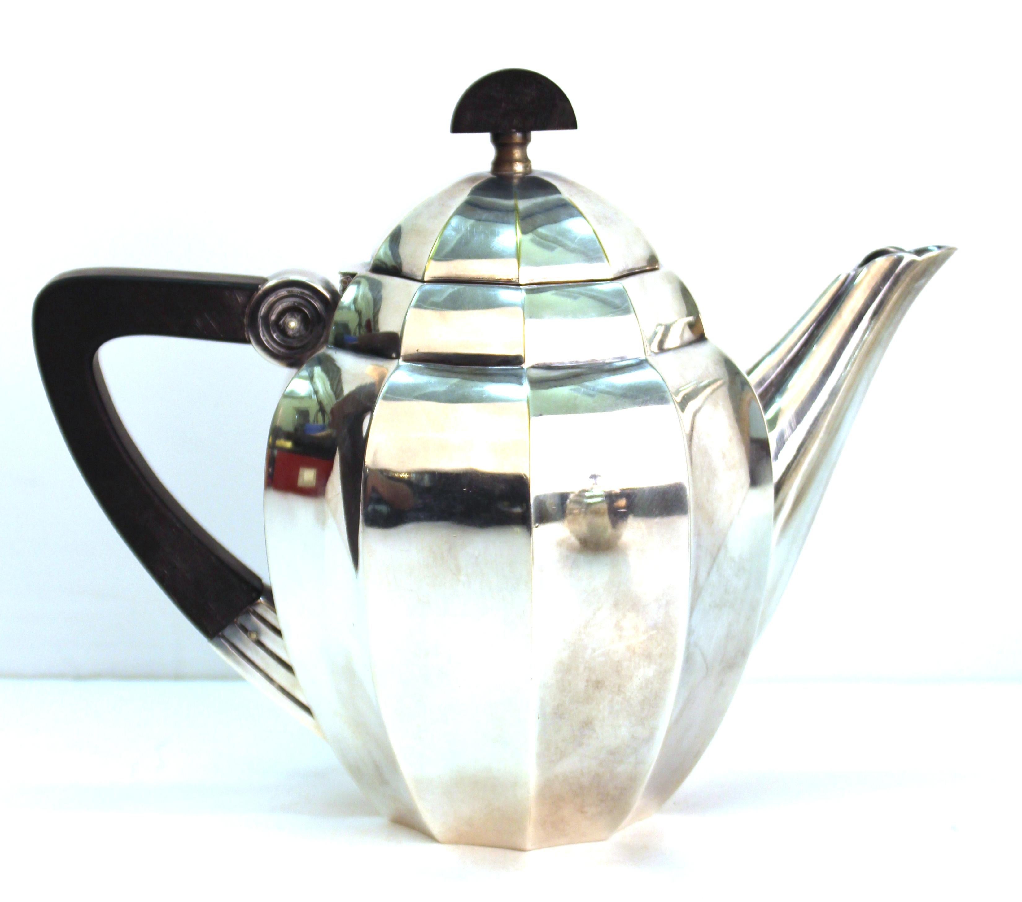 French Art Deco silver plated tea set with ebony handles, created in circa 1925 by French Decorative Designer Maurice Dufrêne (1876-1955) for Orfevrerie Gallia / Christofle.
Dufrêne was known for his Art Deco designs incorporating structure and