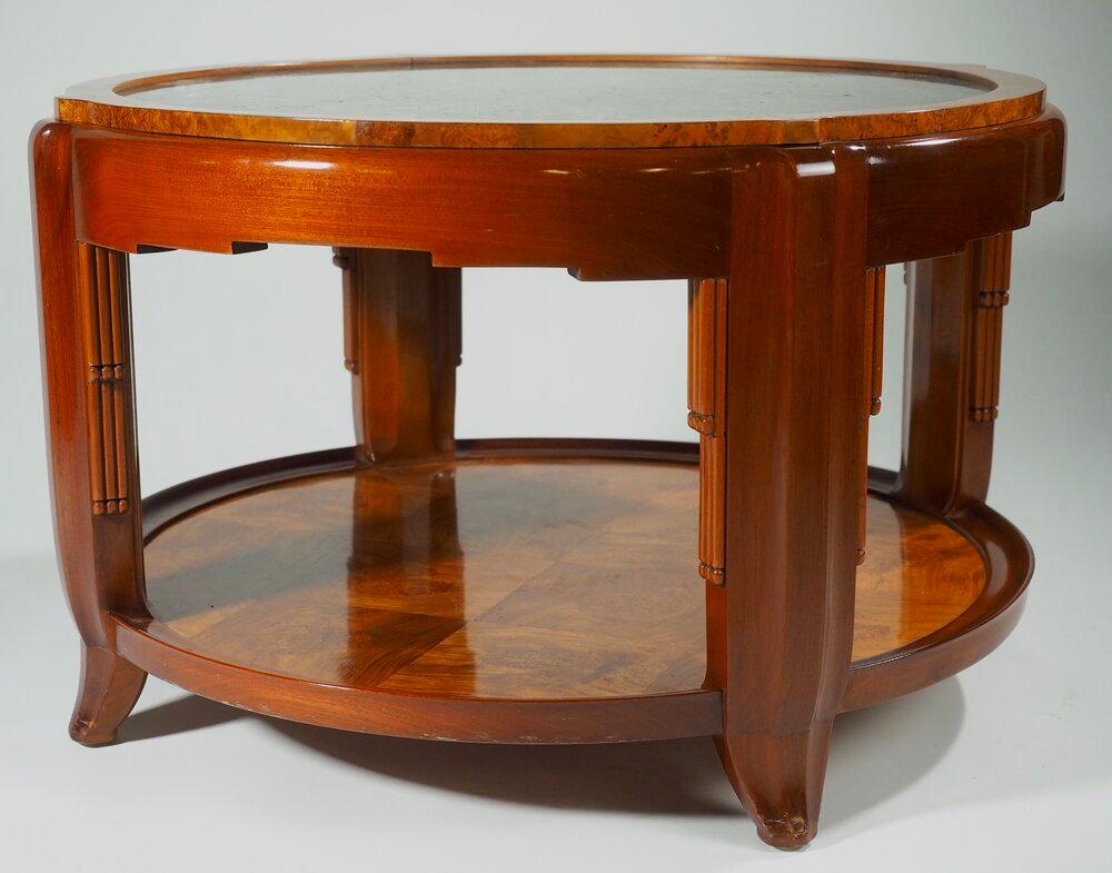 Classic French Art Deco low round side/end/coffee table by Maurice Dufrene, circa 1925, in mahogany, burled mahogany and burled amboyna with marble top. 

Measures: 30” diameter x 18” high.