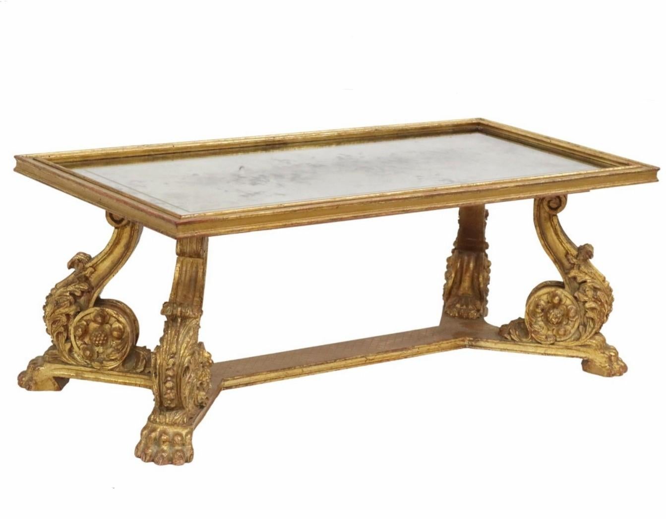 Crafted with an exquisite blend of rich Baroque opulence and timeless French elegance, this stunning carved gilt wood mirrored top cocktail table by Maurice Hirsch stands as a testament to meticulous craftsmanship and artistry. 

Originating in