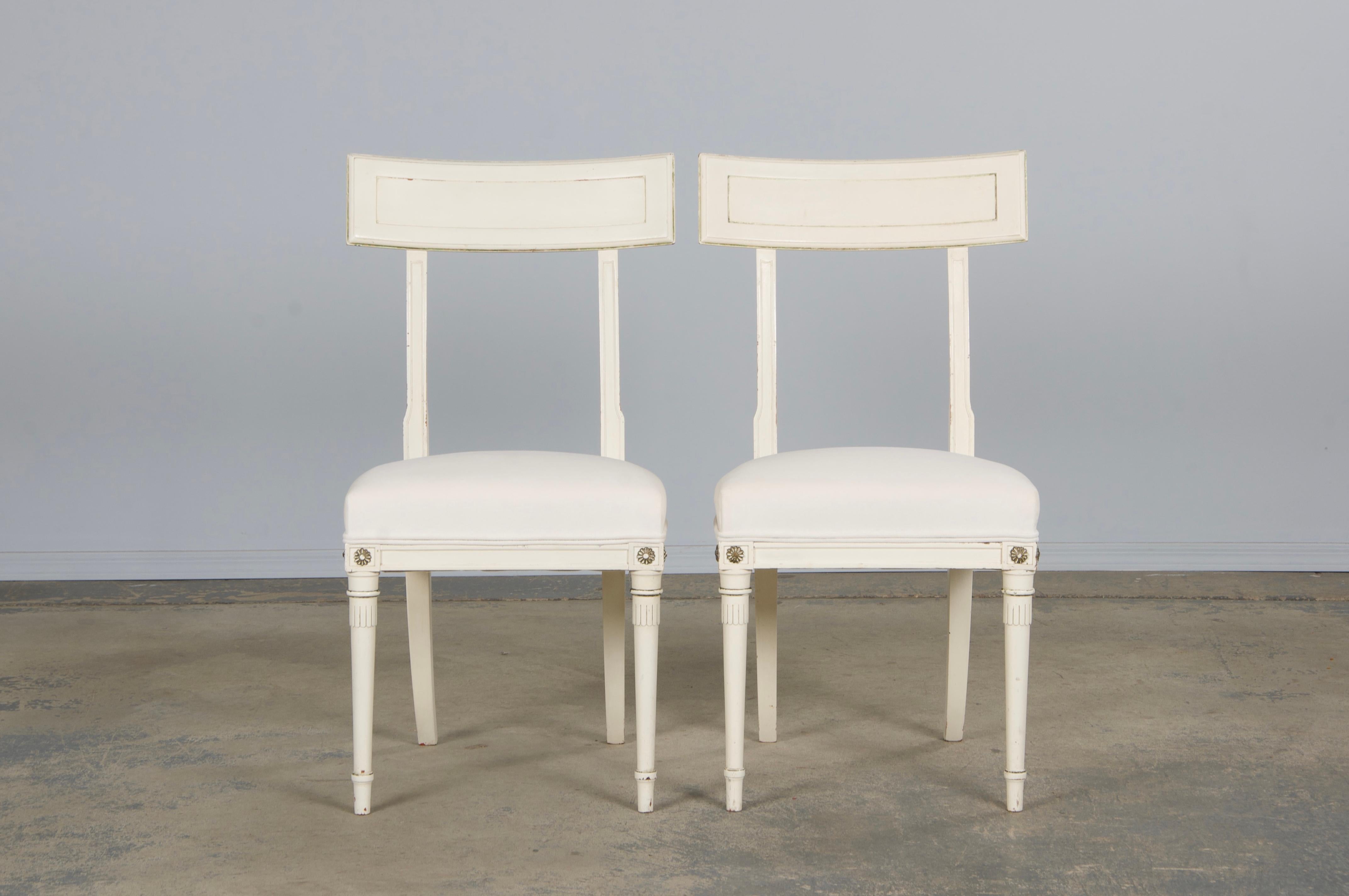 Exquisite mid-20th-century set of six dining chairs by the esteemed French maker Maison Maurice Hirsch, celebrated for neoclassical designs inspired by the grandeur of the Louis XVI period. This particular set also reflects Swedish Gustavian
