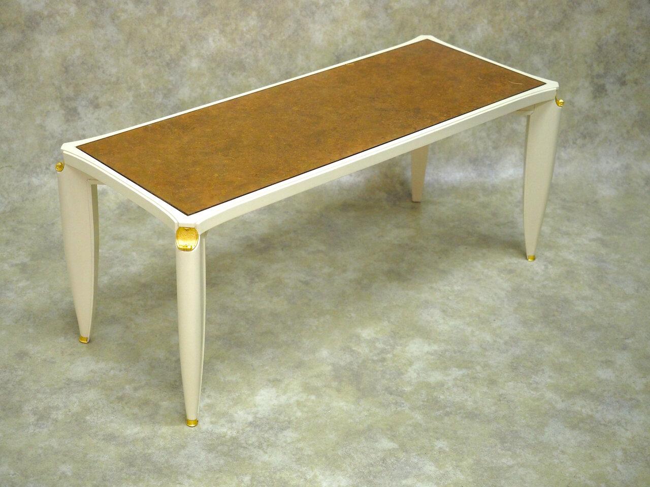 French Forties Art Deco coffee table by Maurice Jallot, circa 1947, in cream lacquer with original verre eglomise glass top and gilt bronze mounts. 40” long x 17” deep x 17” high. Pictured in Mobilier et Decoration, 1947. 

Maurice