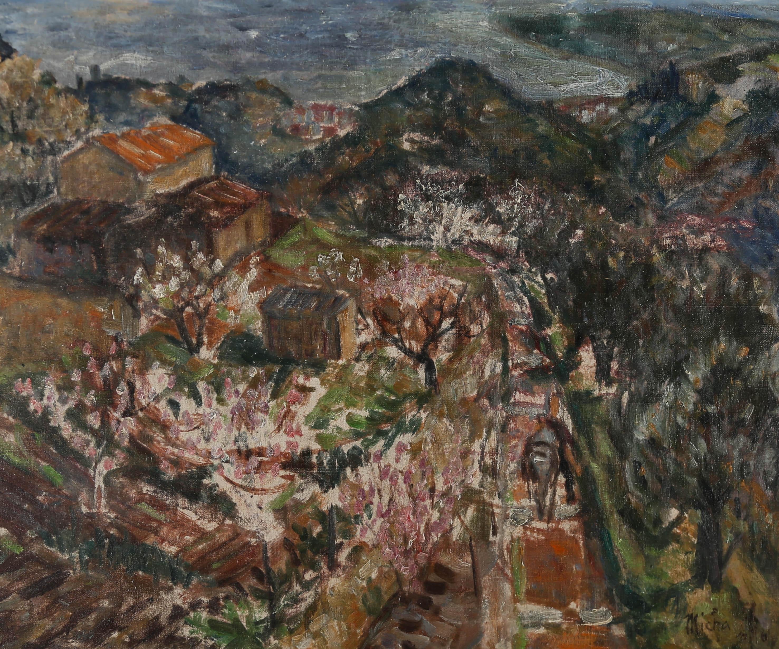 A fine early 20th Century Belgian Impressionist landscape showing the rural hills of the Belgian countryside with blossom trees and farm buildings. The artist's use of darker, more muted tones in the distant hills adds gravity and highlights the