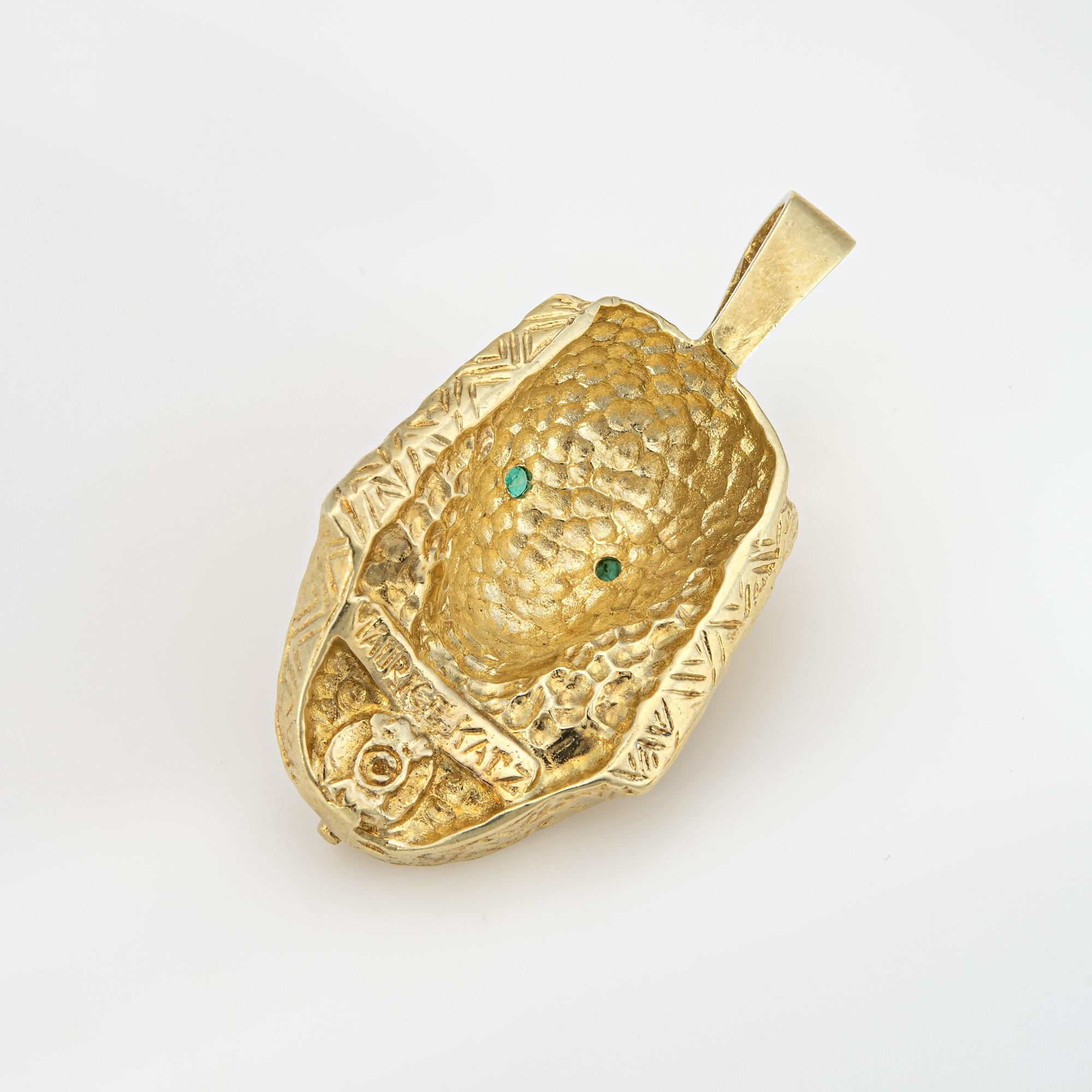 Finely detailed vintage Maurice Katz Egyptian Pharaoh pendant crafted in 14 karat yellow gold. 

Two small emeralds are set into the eyes and total an estimated 0.04 carats. 

The beautifully detailed pendant highlights the intricate craftsmanship