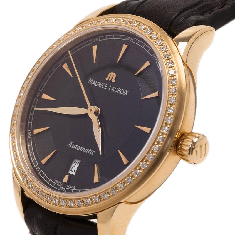 Chic and stylish, this timepiece from Maurice Lacroix will never fail you. Made from 18K yellow gold, the watch features a round case holding a diamond studded bezel with a black dial. It comes with gold-tone index markers, a date window and a brand