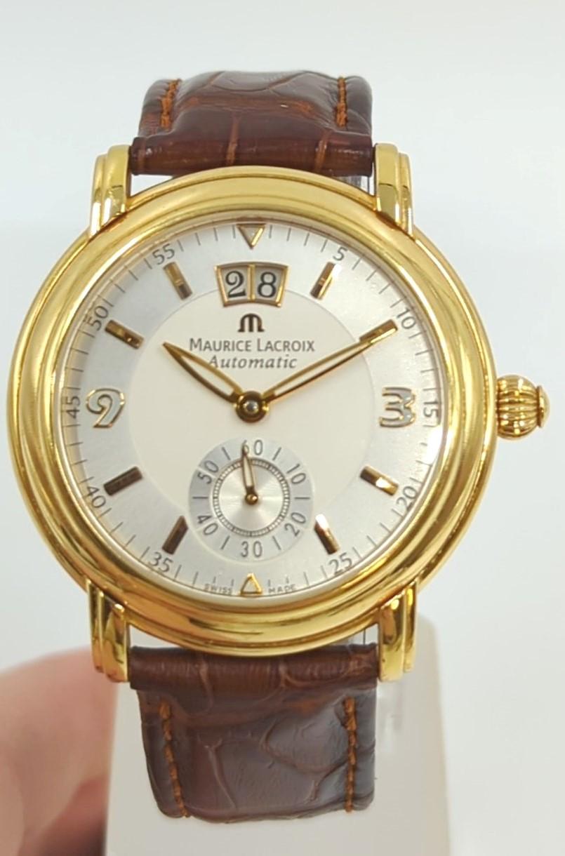 Maurice Lacroix Masterpiece gent's wristwatch in solid 18k yellow gold. This fine Swiss timepiece features elegant “big date