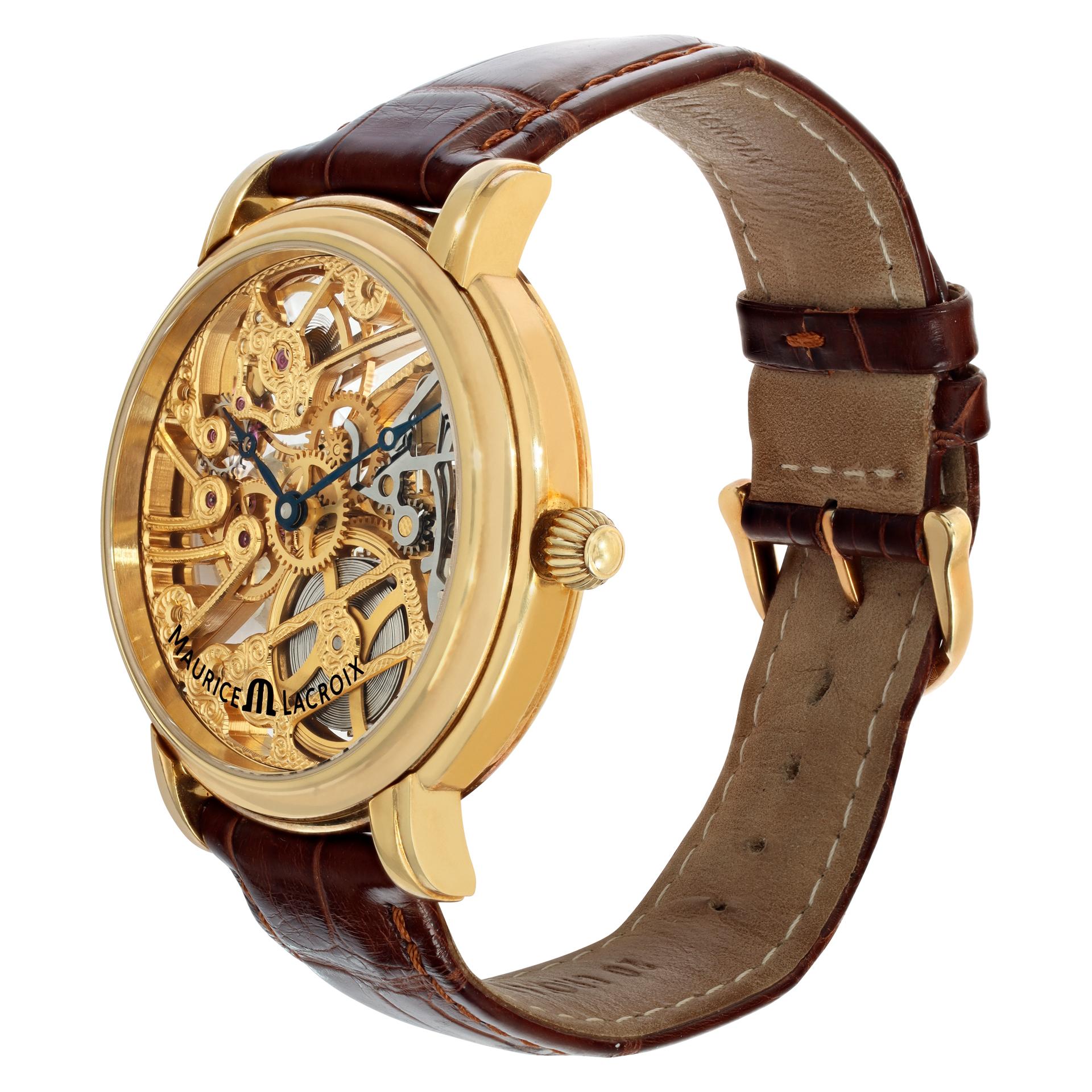 Maurice Lacroix Squelette in 18k yellow gold on a brown leather strap. Manual with 18k tang buckle. 43 mm case size. Ref MP7048. Fine Pre-owned Maurice Lacroix Watch.

 Certified preowned Dress Maurice Lacroix Squelette MP7048 watch is made out of