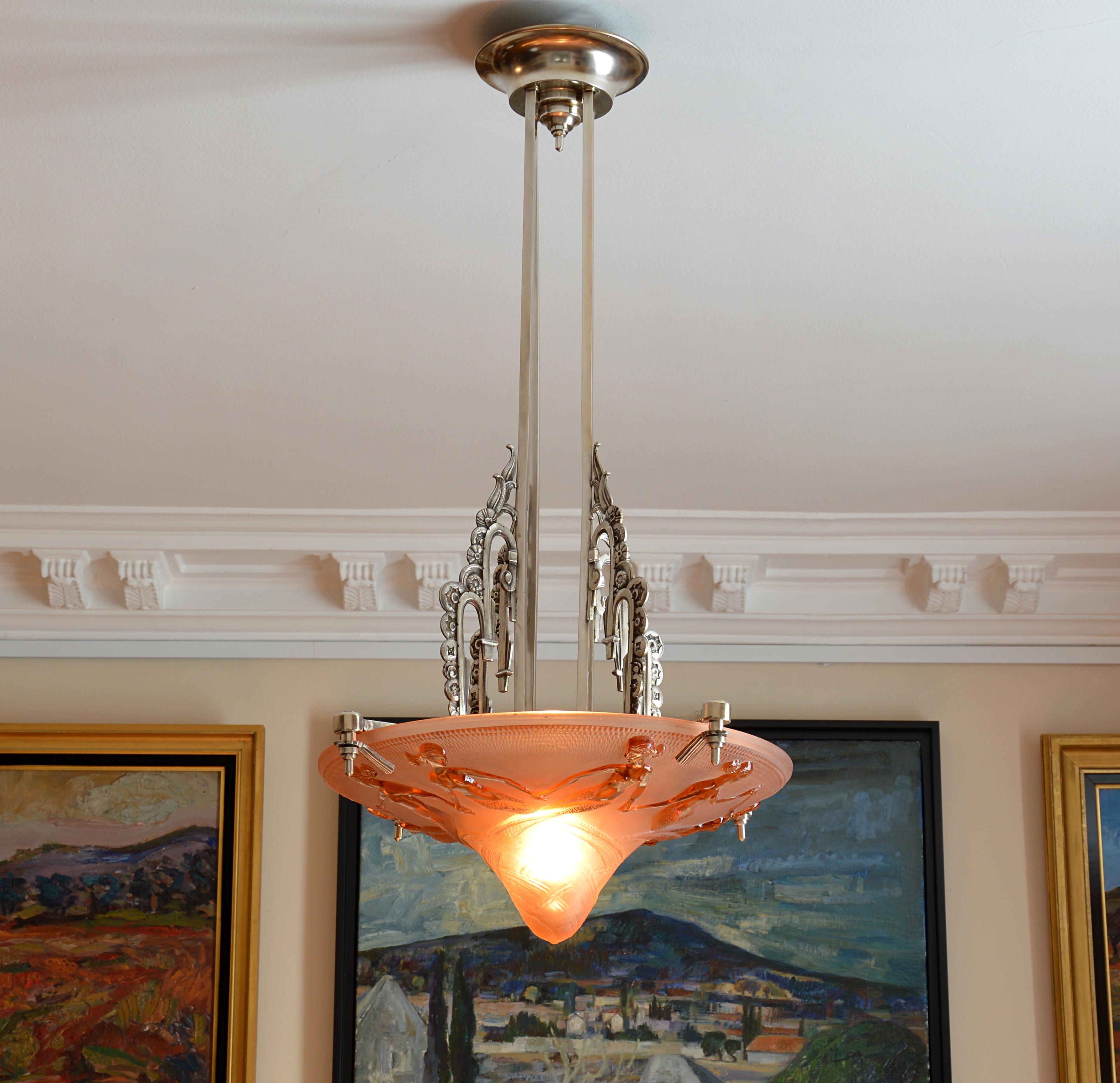 French Art Deco pendant chandelier by Maurice Model, Verdun, France, 1930s. Very thick molded-pressed glass bowl with a pattern of a round of eight mermaid in relief suspended on a silver plated bronze and brass fixture representing a Cascade of