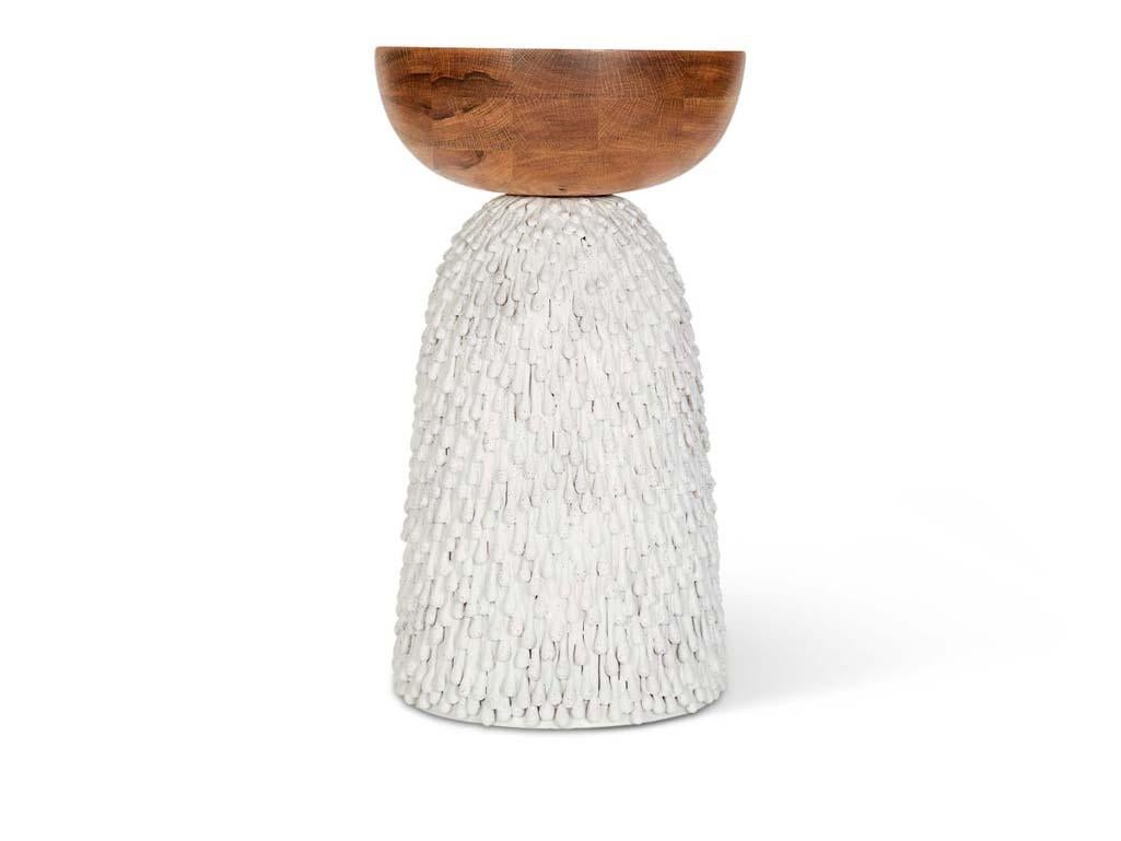 The Maurice Side Table features a walnut top and handmade ceramic base by artist Natan Moss.