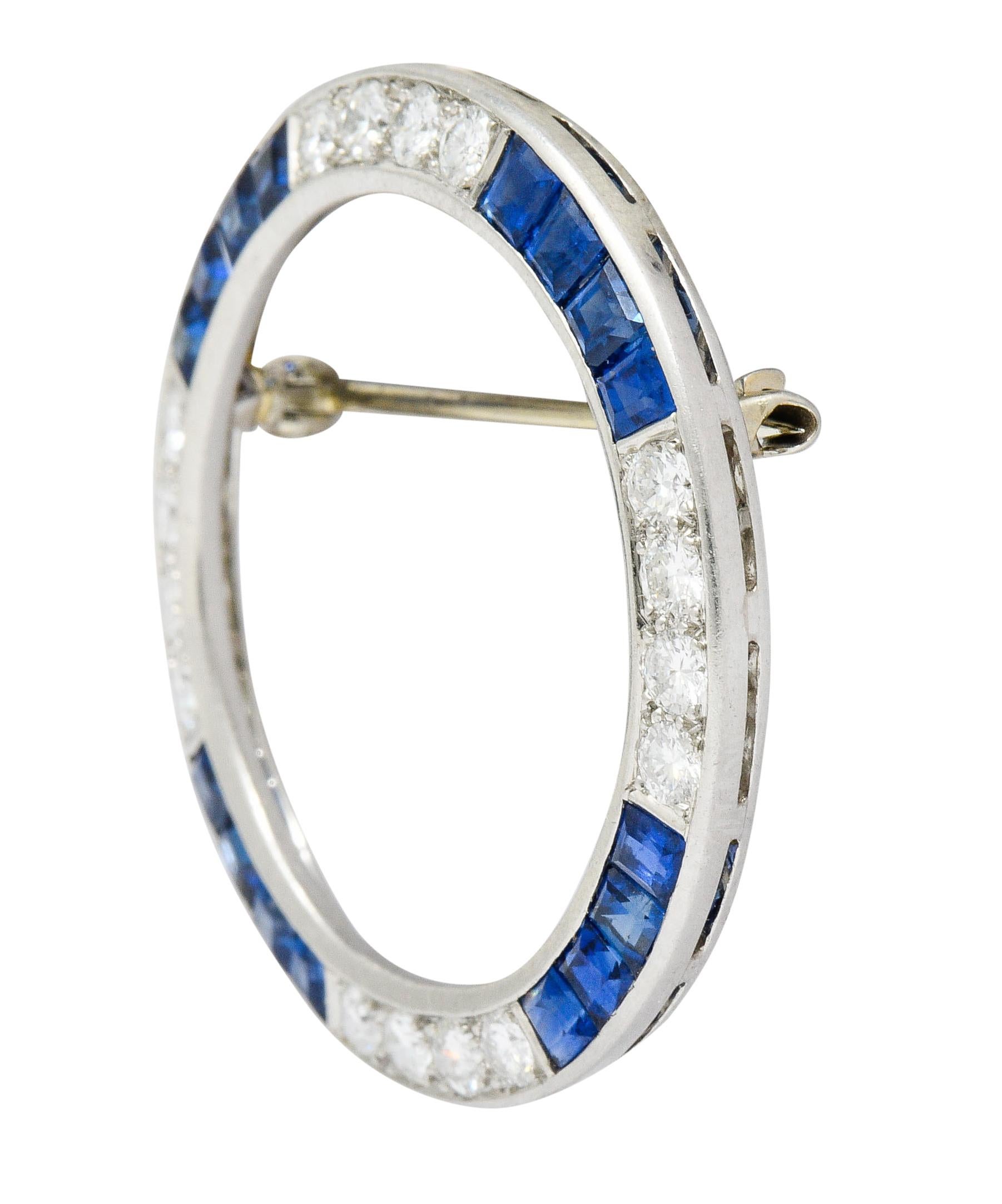 Circular brooch is designed as sections of channel set calibrè cut sapphire alternating with bead set round brilliant cut diamonds

Sapphires are a very well-matched bright blue color and weigh in total approximately 3.05 carats

Diamonds weigh in