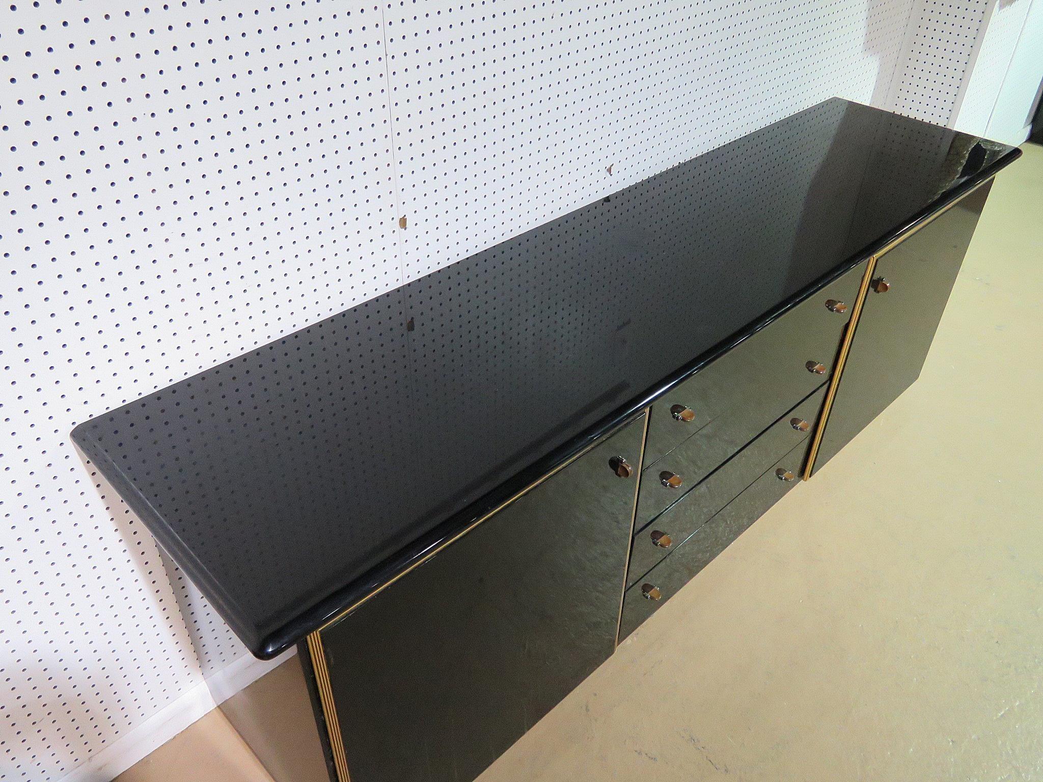 Mid-Century Modern sideboard with black polished finish and blonde wood trim.
(Please confirm item location - NY or NJ - with dealer).
   