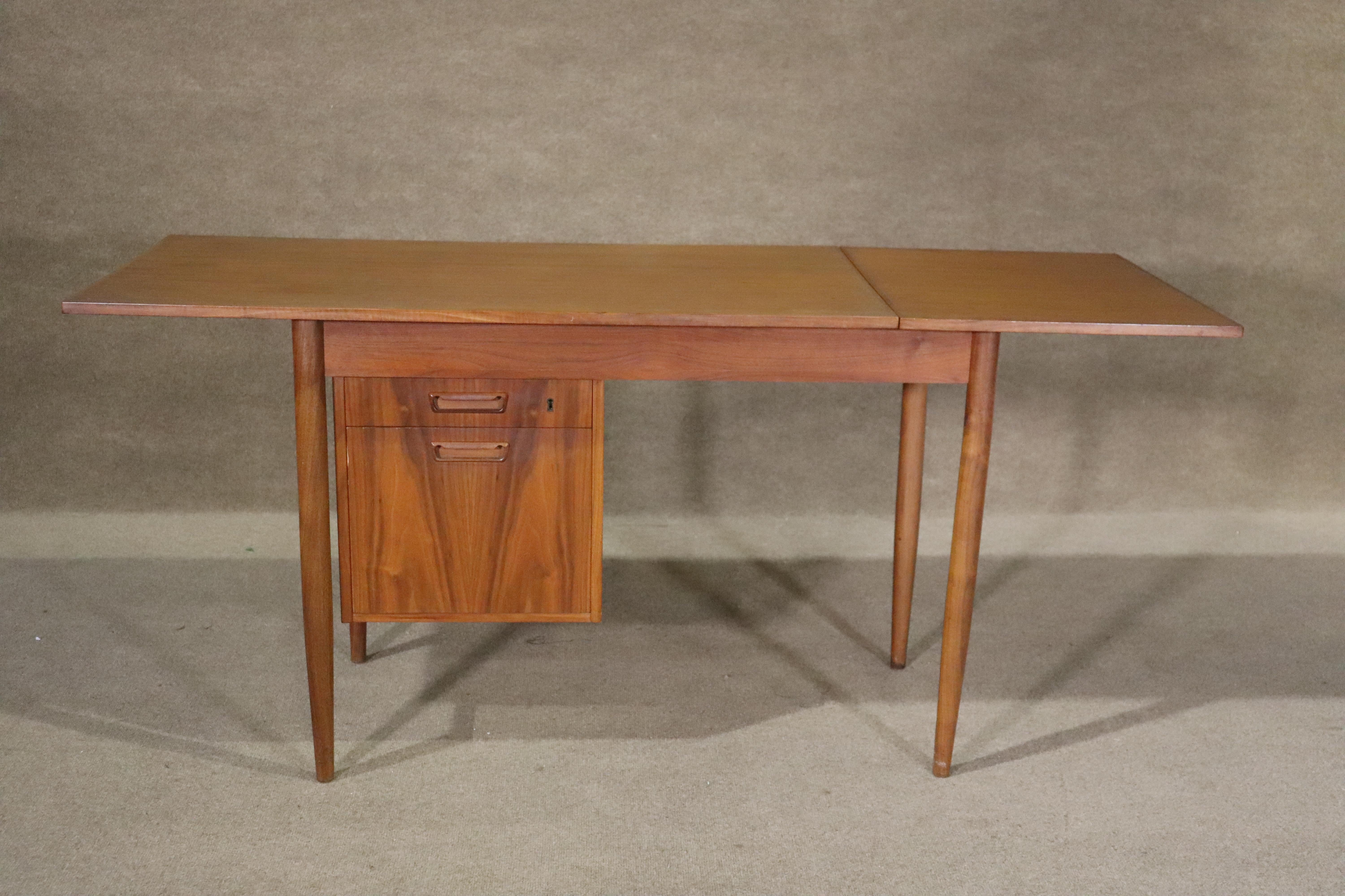 Mid-century modern teak desk by Maurice Villency. Features movable drawers and a 19