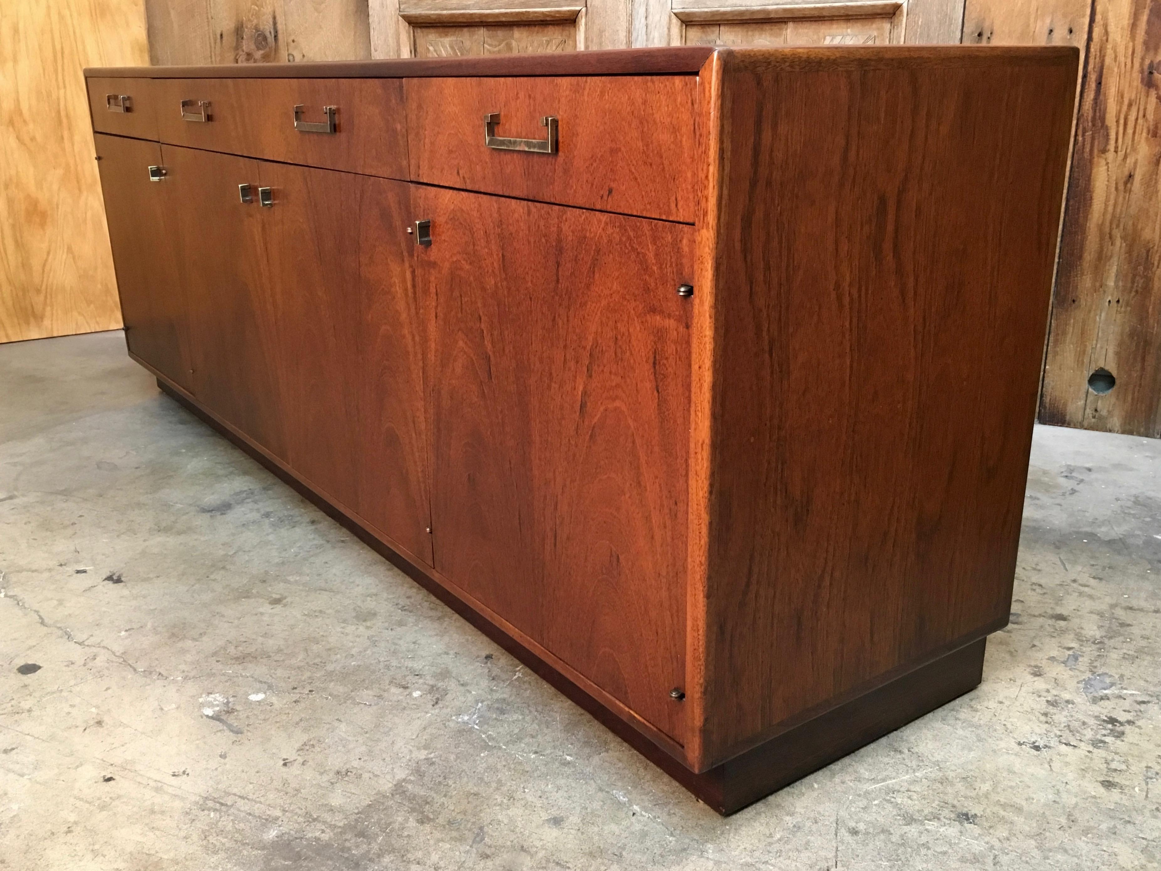 Book match Veneer front three drawer and four door credenza with brass hardware designed by Maurice Villency of New York.