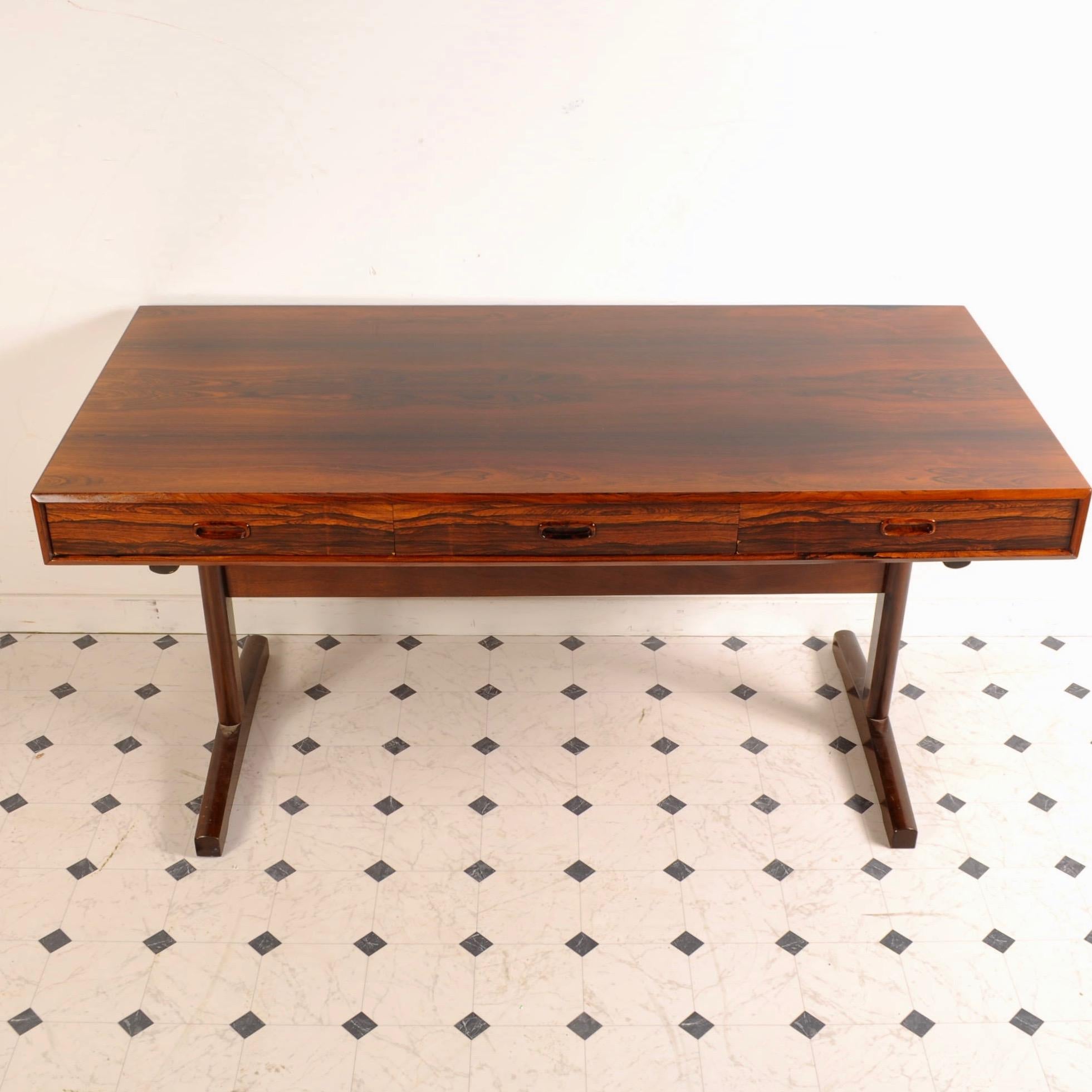 Great Danish design in a solidly built rosewood desk, perfect for today's downsized office needs. Finished on all sides this desk can easily float out from the walls.