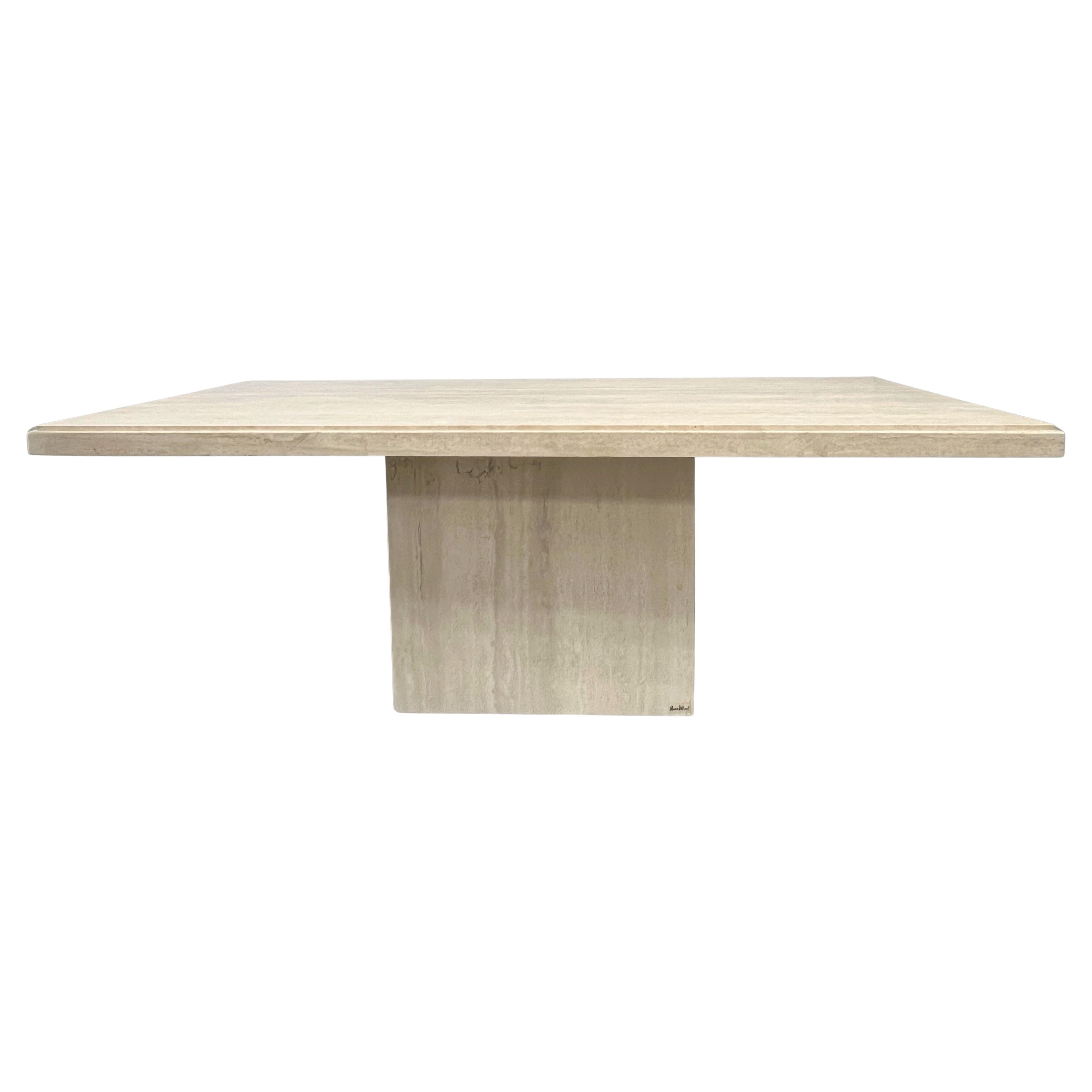 A monolithic travertine dining table. Minimalist rectangular design. Beautiful subtle graining.  Very simple design. The top rest on the rectangular base. Honed finish. Signed on base. 