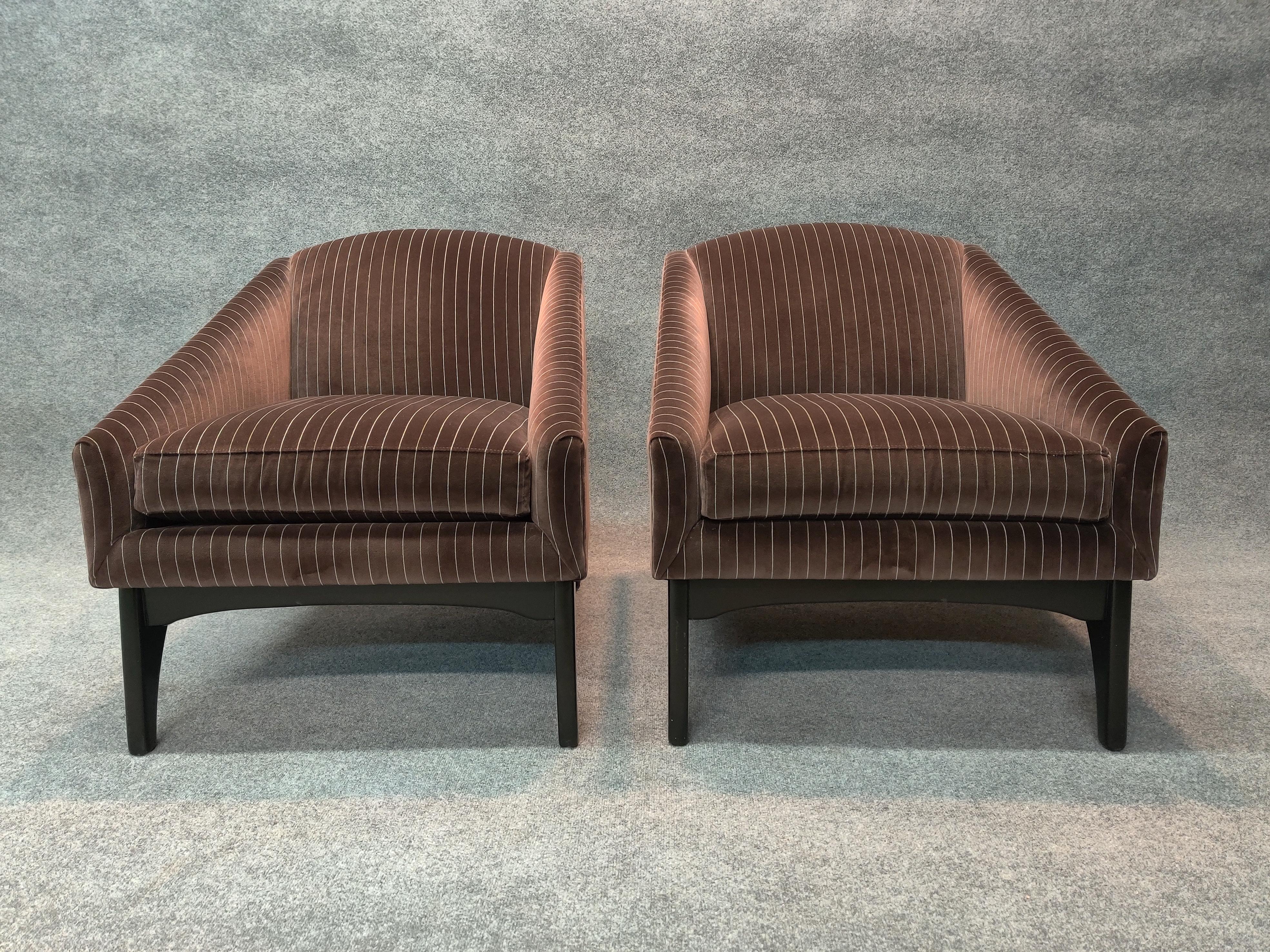 This pair of visually pleasing chairs are very well made. Subtle design details include Mid-century inspired contoured wood legs, a deep and comfortable seating area, a warm dark brown upholstery with attractively contrasting grey striping. 

Super