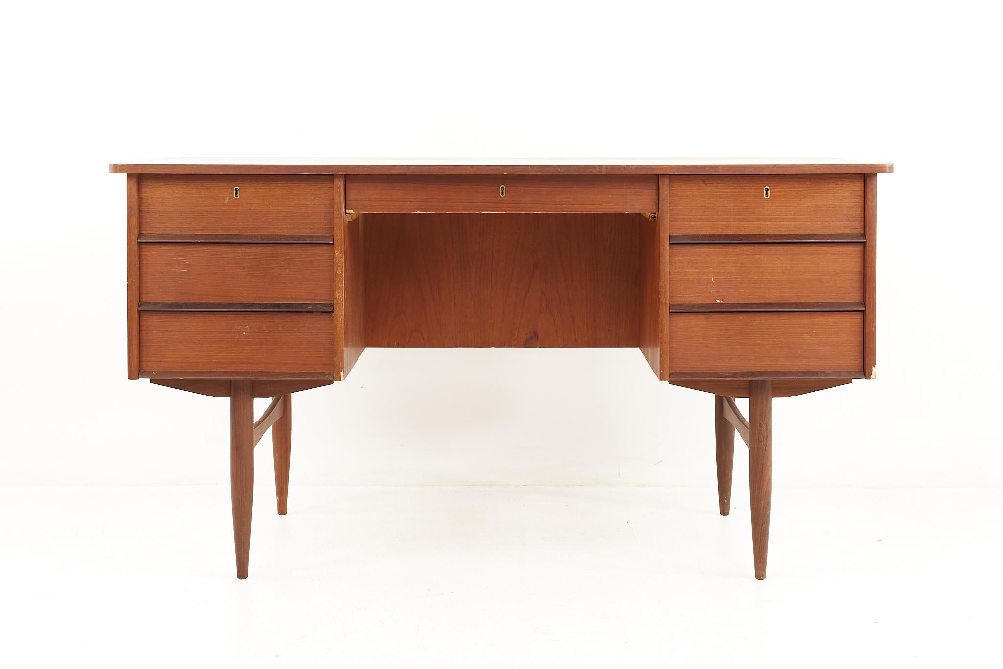 Maurice Villency style mid century teak desk with bookcase front

The desk measures: 52.5 wide x 26.25 deep x 28.75 high, with a chair clearance of 25.25 inches 

All pieces of furniture can be had in what we call restored vintage condition.