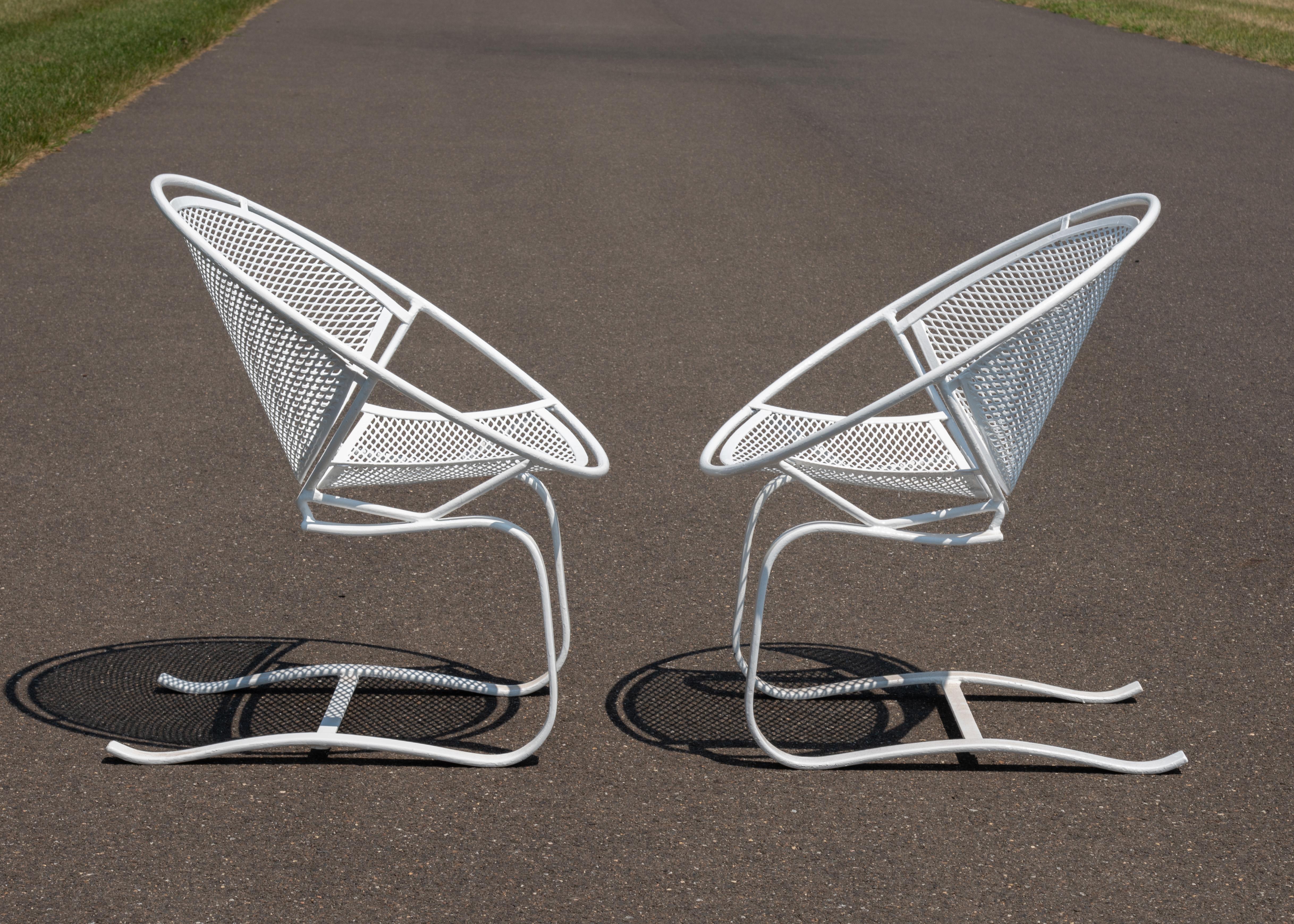 A pair of Maurizio Tempestini designed cantilevered Radar spring chairs for Salterini, Ca. 1950s. Iconic Mid Century Modern design, hoop frame, metal mesh seat and back, cantilevered to allow bounce or spring action.
These hard to find chairs are