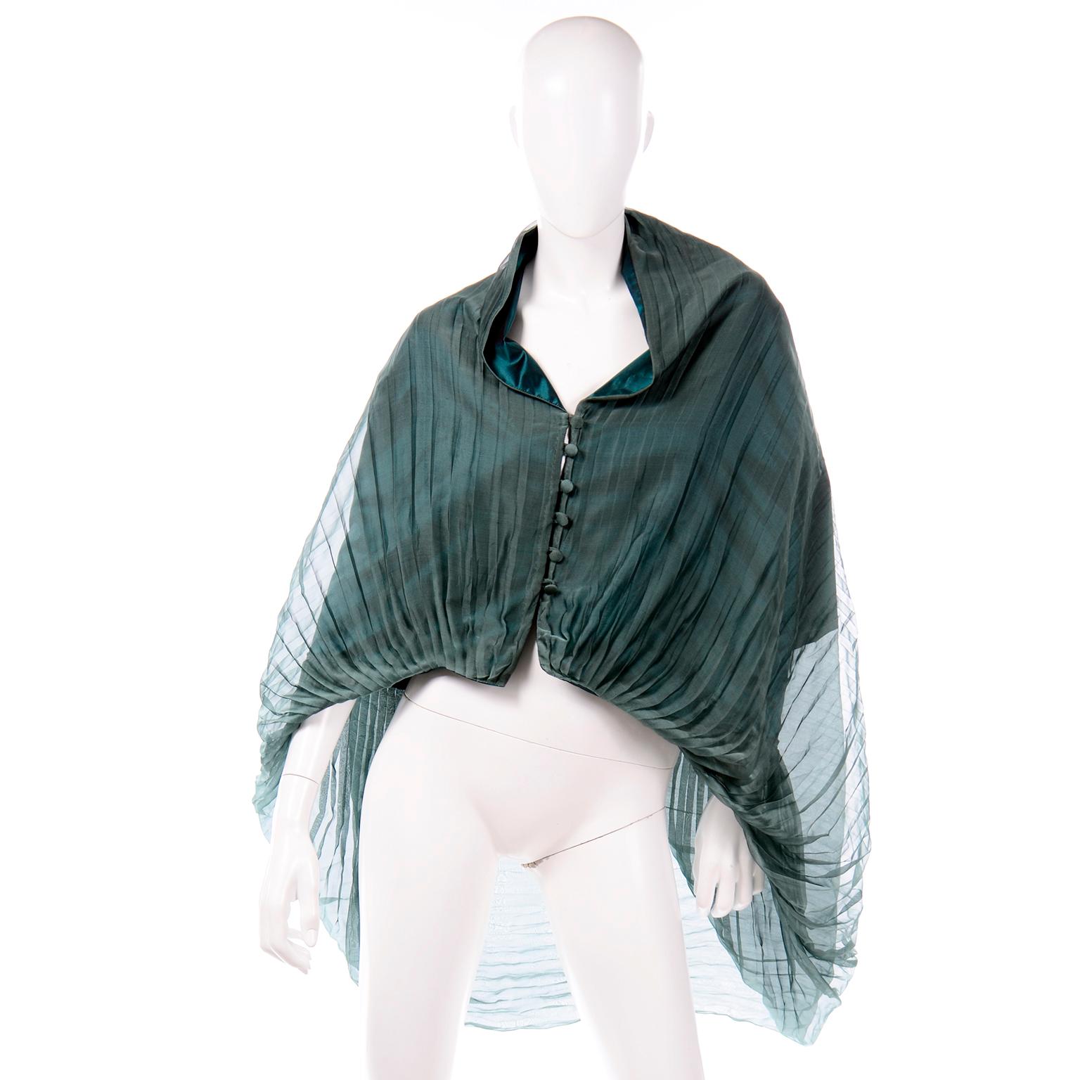 This is a stunning vintage green evening cape style pleated top from Maurizio Galante for Circolare. This incredible top has green silk taffeta under the pleated sheer organza overlay.  The top can be worn in a variety of ways and has a button in