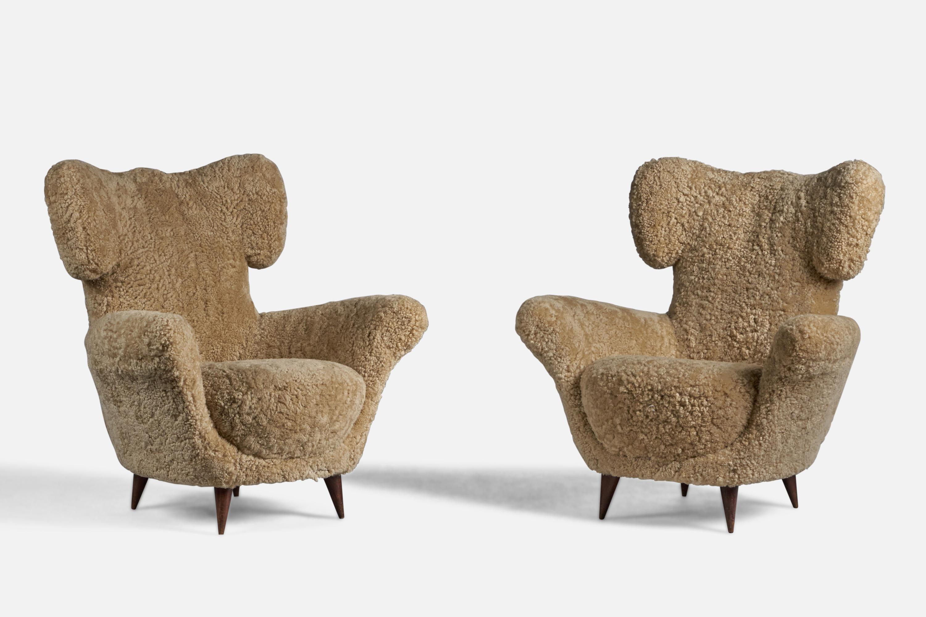 A pair of organic beige shearling and dark-stained wood lounge chairs attributed to Maurizio Tempestini, Italy, 1940s.

16.5