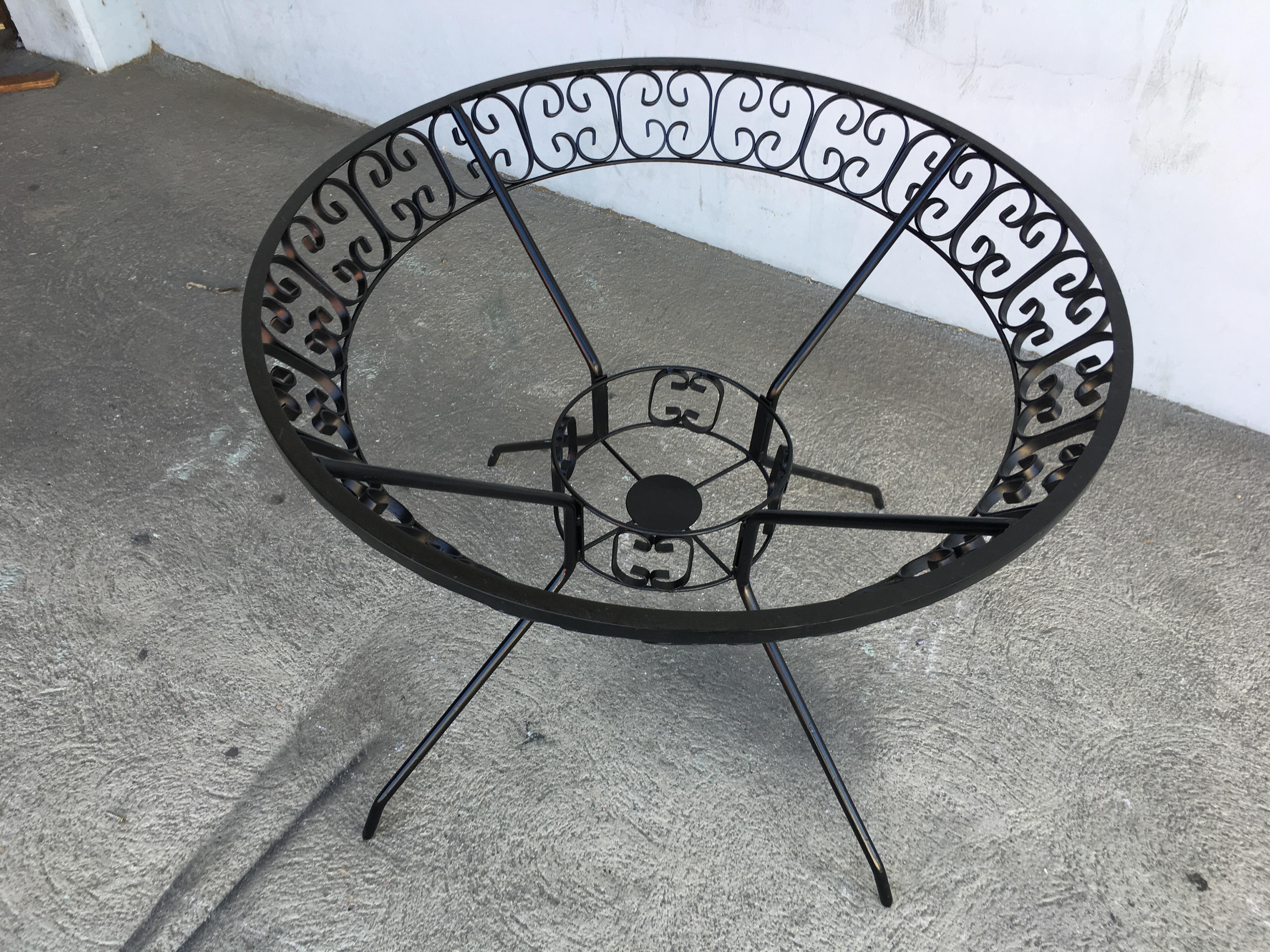 Midcentury iron and glass outdoor patio/outdoor picnic table designed by Maurizio Tempestini for the Salterini company. It comes with the iconic side Ribbon scrolling patterns of Maurizio Tempestini during the 1950s and 1960s.
