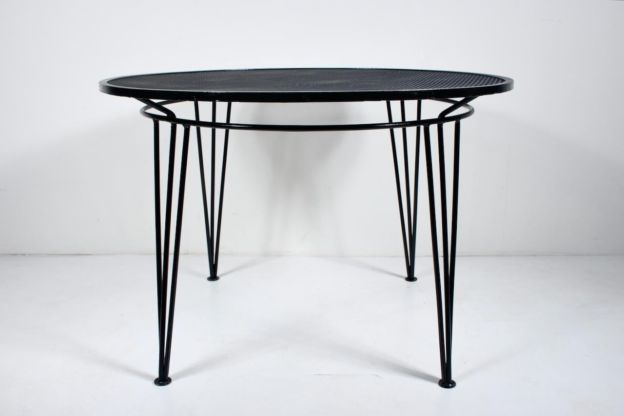 Original Maurizio Tempestini for Salterini Black Iron and Wire DIning Table. Featuring Tempestini classic round wrought iron framework with three part legs, sturdy round woven metal mesh surface. Professionally refinished and coated in high Gloss