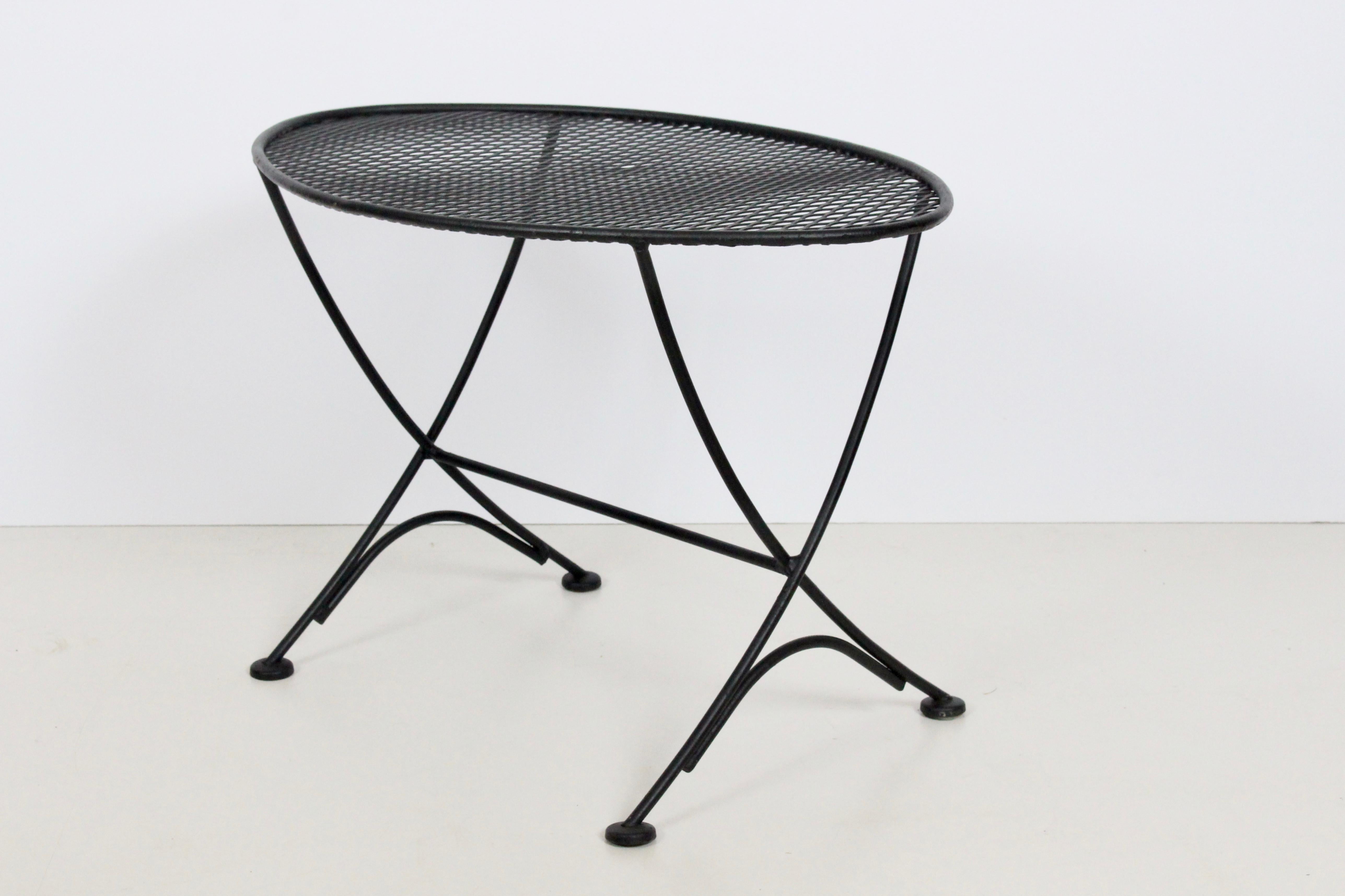 Original Maurizio Tempestini for Salterini black wrought iron and metal mesh oval occasional table, small coffee table, end table, side table. for indoor / outdoor use. Kindly note that Professional Packaging costs will be needed to ensure safe and