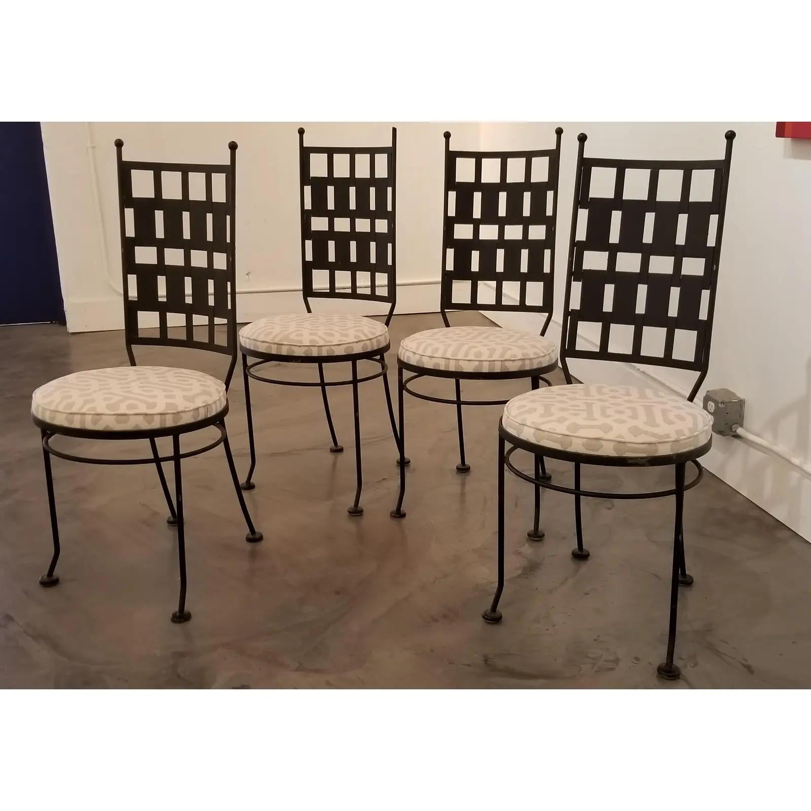A set of 4 geometric iron and steel Brutalist patio or dining chairs by Maurizio Tempestini, circa 1960s. Newly upholstered seats with Sunbrella material. All original foot glides intact, missing one finial.
