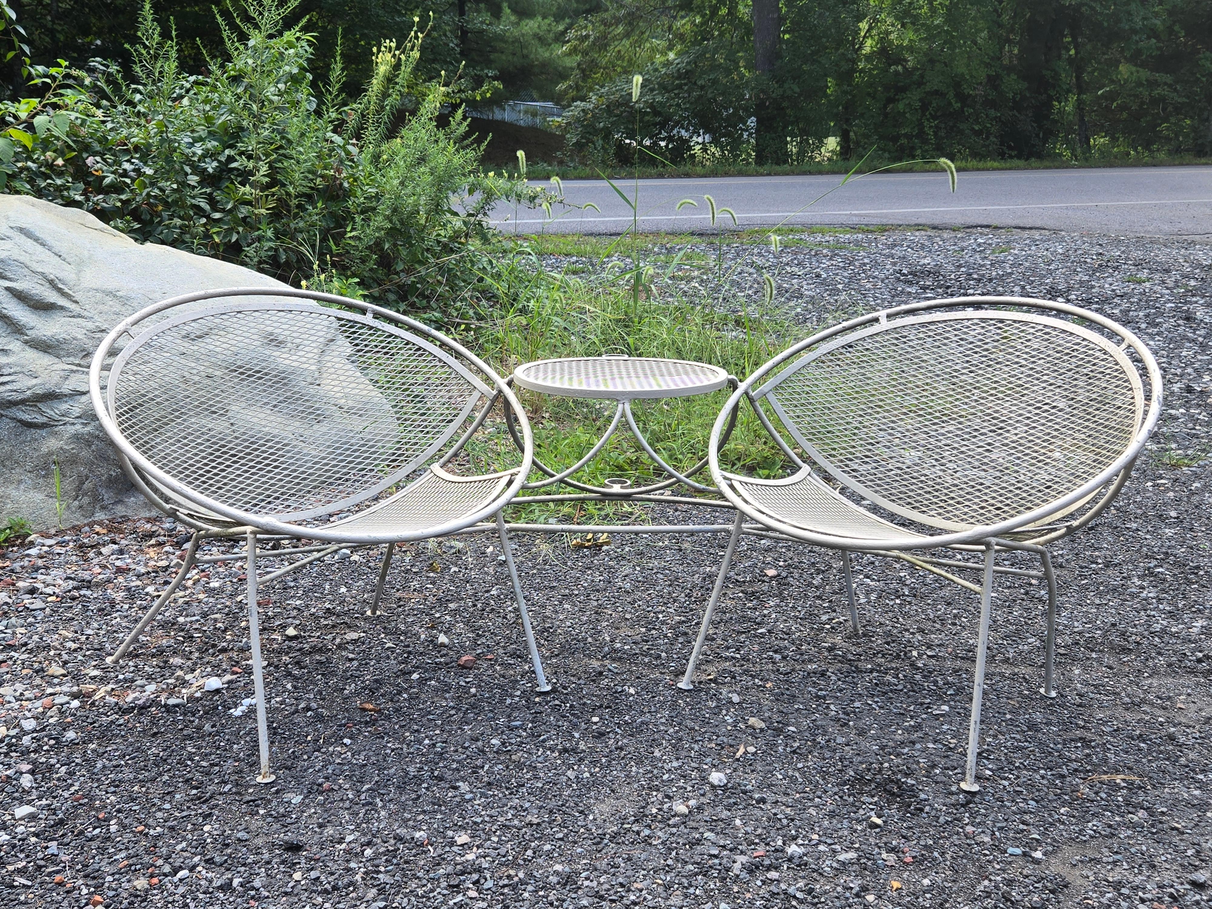 A Set of Radar Chairs by Maurizio Tempestini for Salterini

Rare and hard to find Tete-a-Tete set of 2 Radar Chairs with an attached table in between. The table gives you a perfect place to rest a cocktail and features an umbrella holder to provide